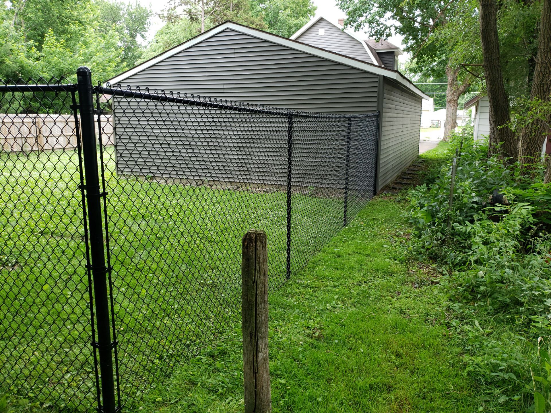 Black Vinyl Chain Link Fence Installation in Charles City by Perfect Picket Fence and Stain