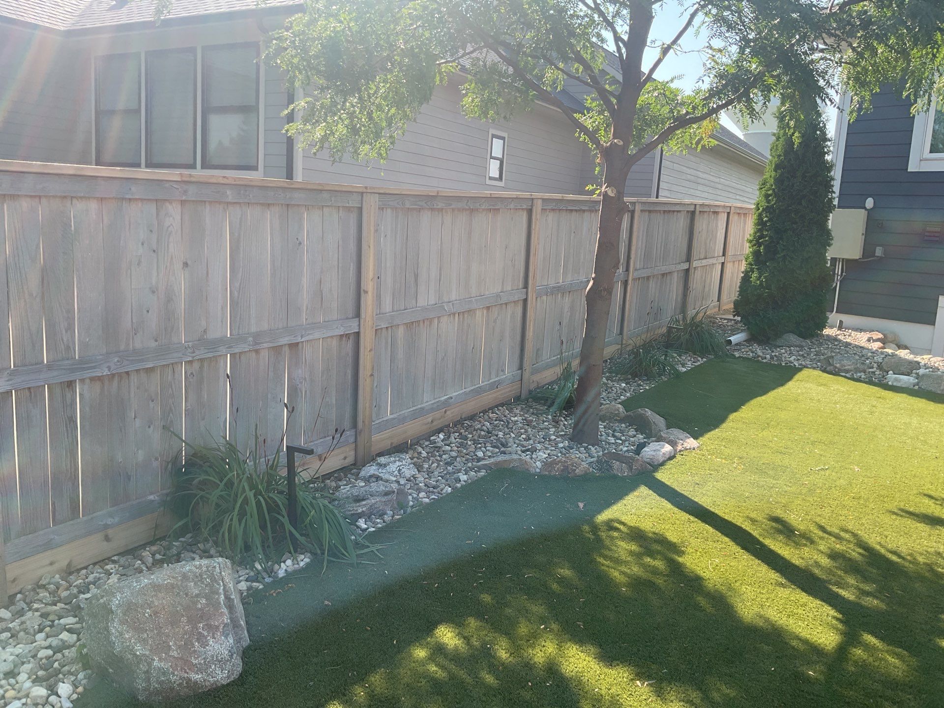 Custom Privacy Fence and Paver Patio Installation in Sioux Falls by Select Painting, Coatings & Garage Cabinets