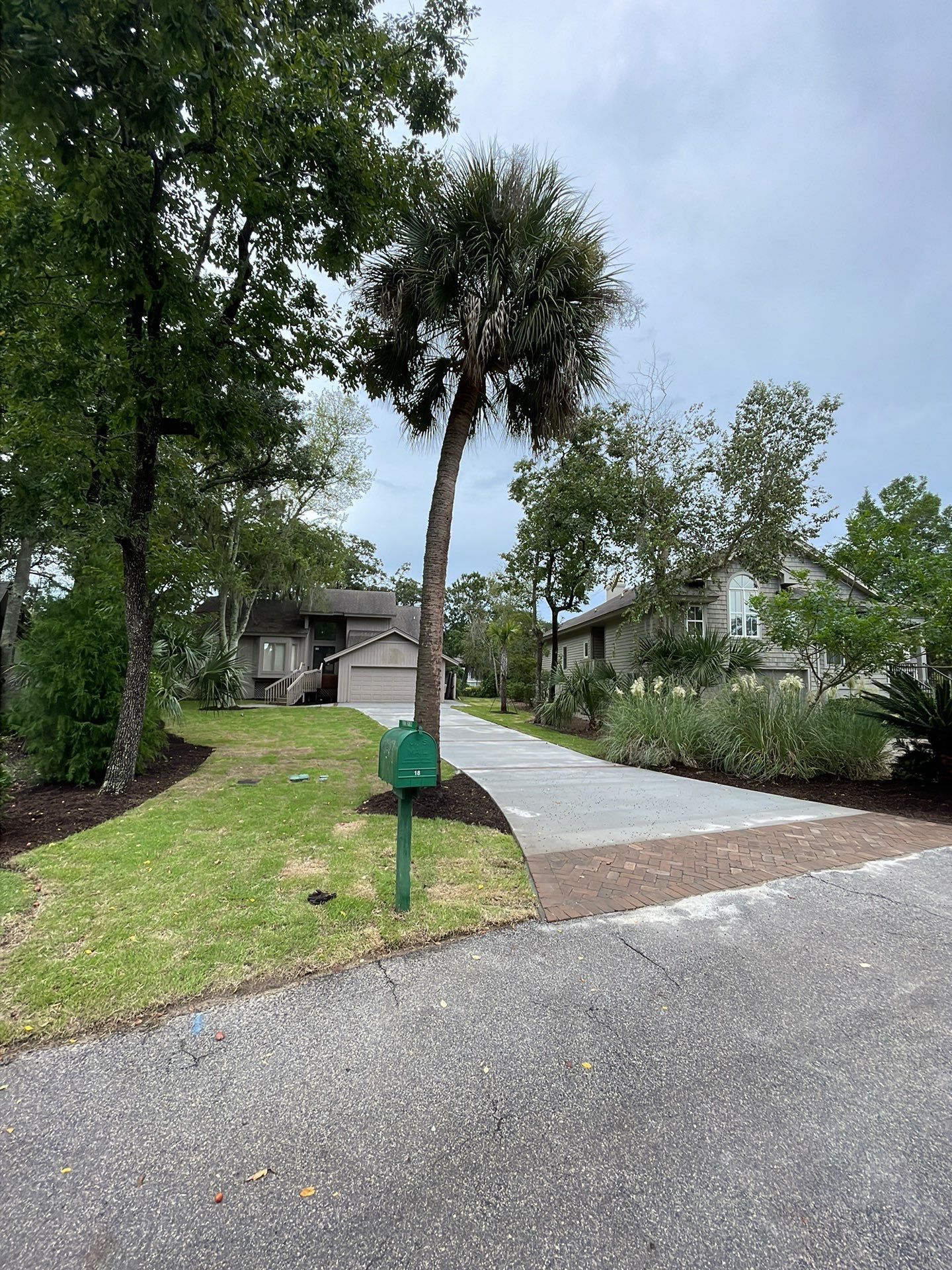 Concrete Driveway Replacement with Brick Paver Accents in Hilton Head Island by Lowcountry Scapes, LLC