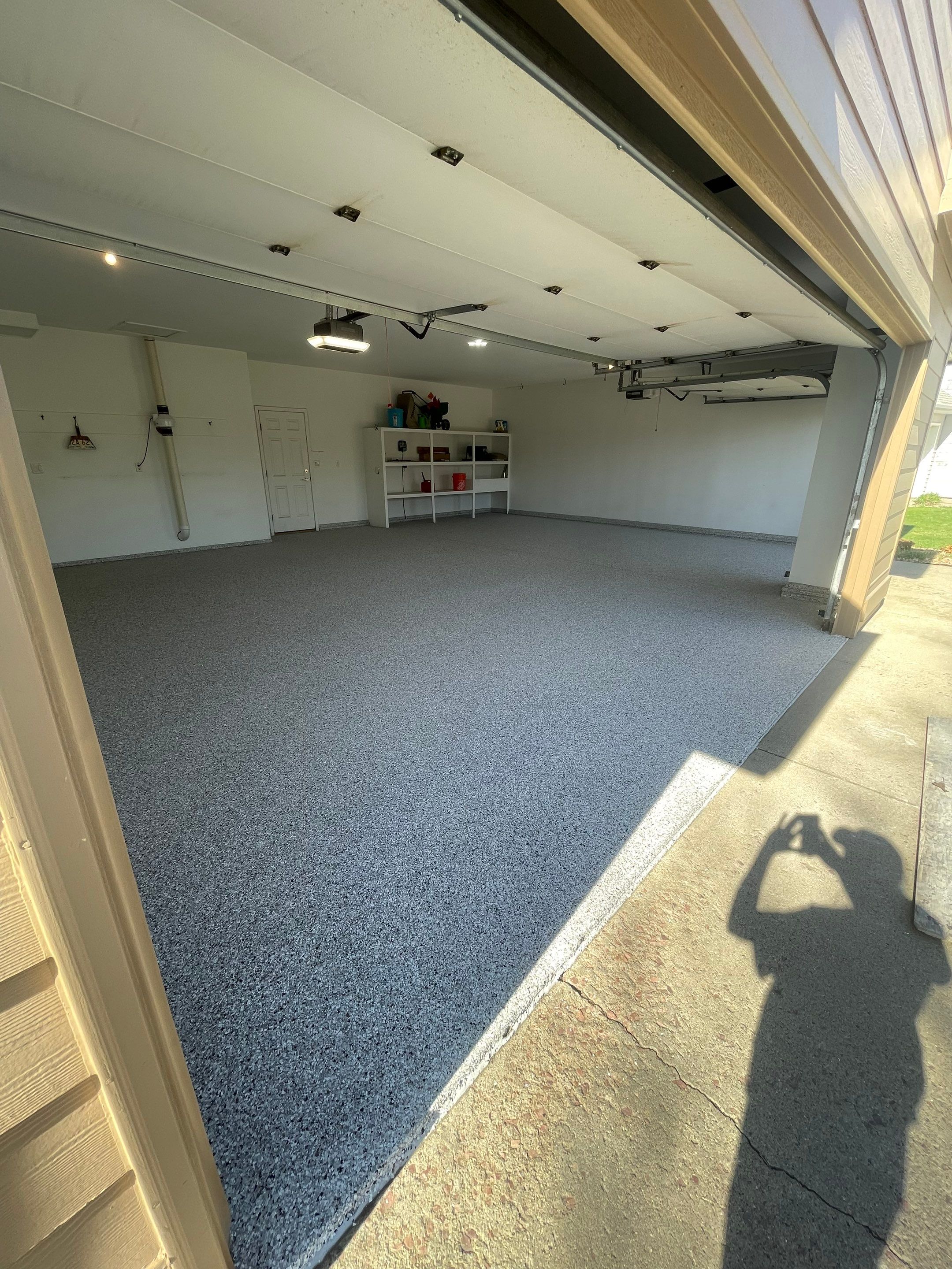 Yankton Garage Floor Restoration with Gray Speckled Epoxy Coating by Select Painting, Coatings & Garage Cabinets