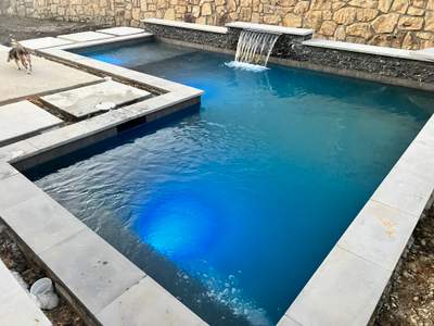Geometric Pool with Raised Spa and Dusk Lighting