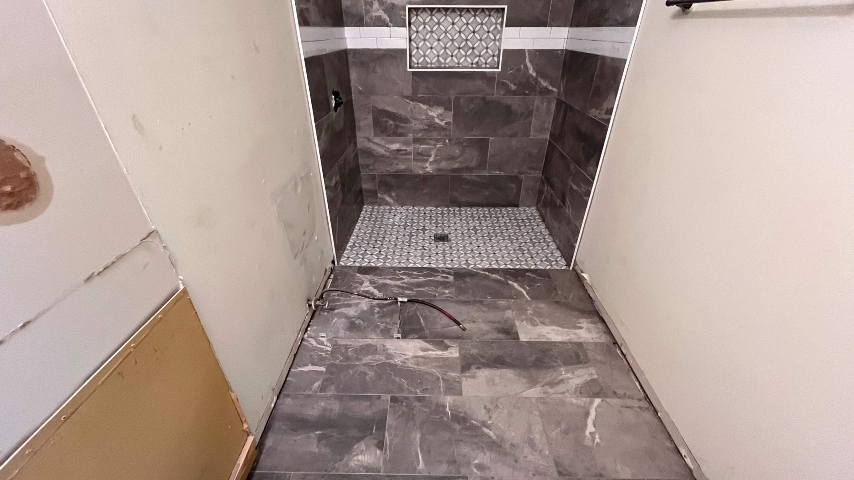 Tub to a curbless walk-in shower by Prudencio