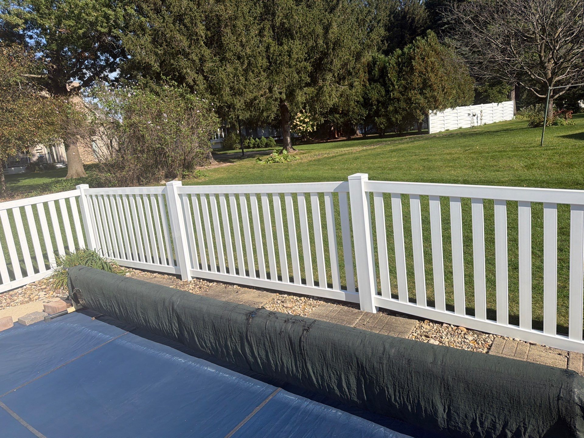 White Vinyl Picket Pool Fence Installation in Waterloo, Iowa by Perfect Picket Fence and Stain