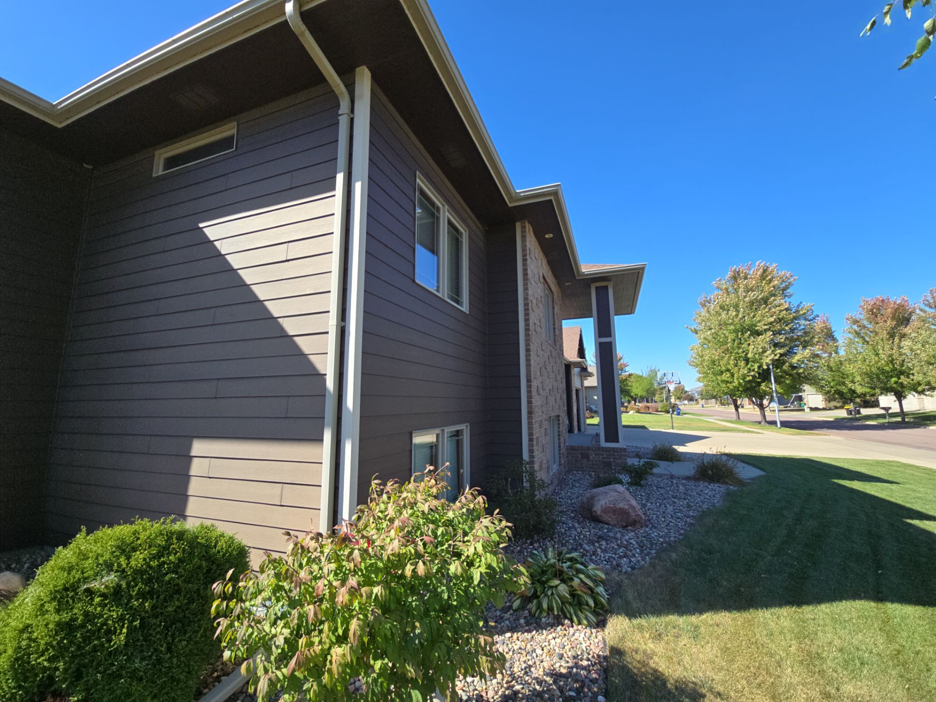 Dark Blue Exterior Home Painting and Siding Refresh in Sioux Falls by Select Painting, Coatings & Garage Cabinets