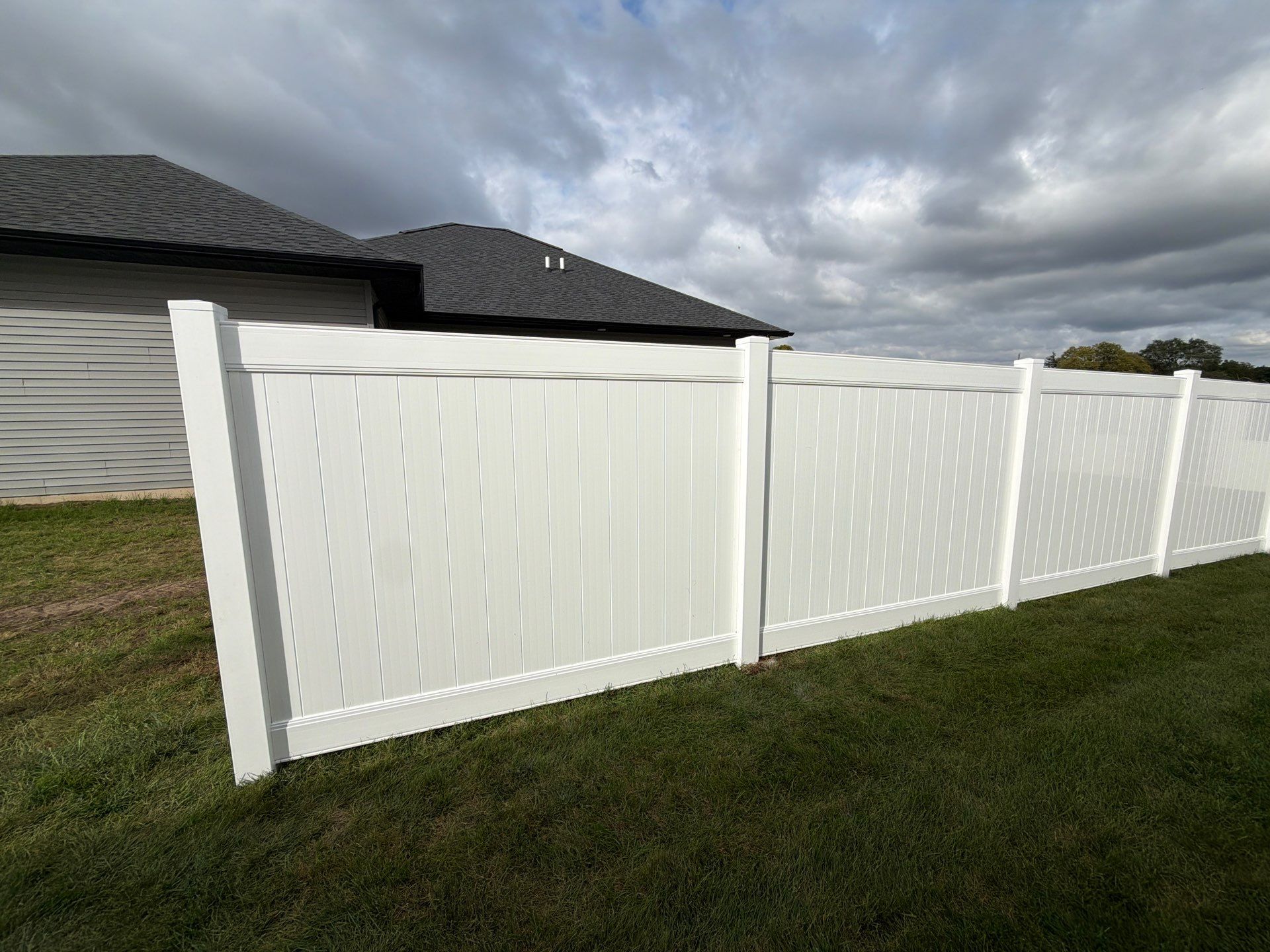 Residential White Vinyl Privacy Fence Installation in Janesville by Perfect Picket Fence and Stain