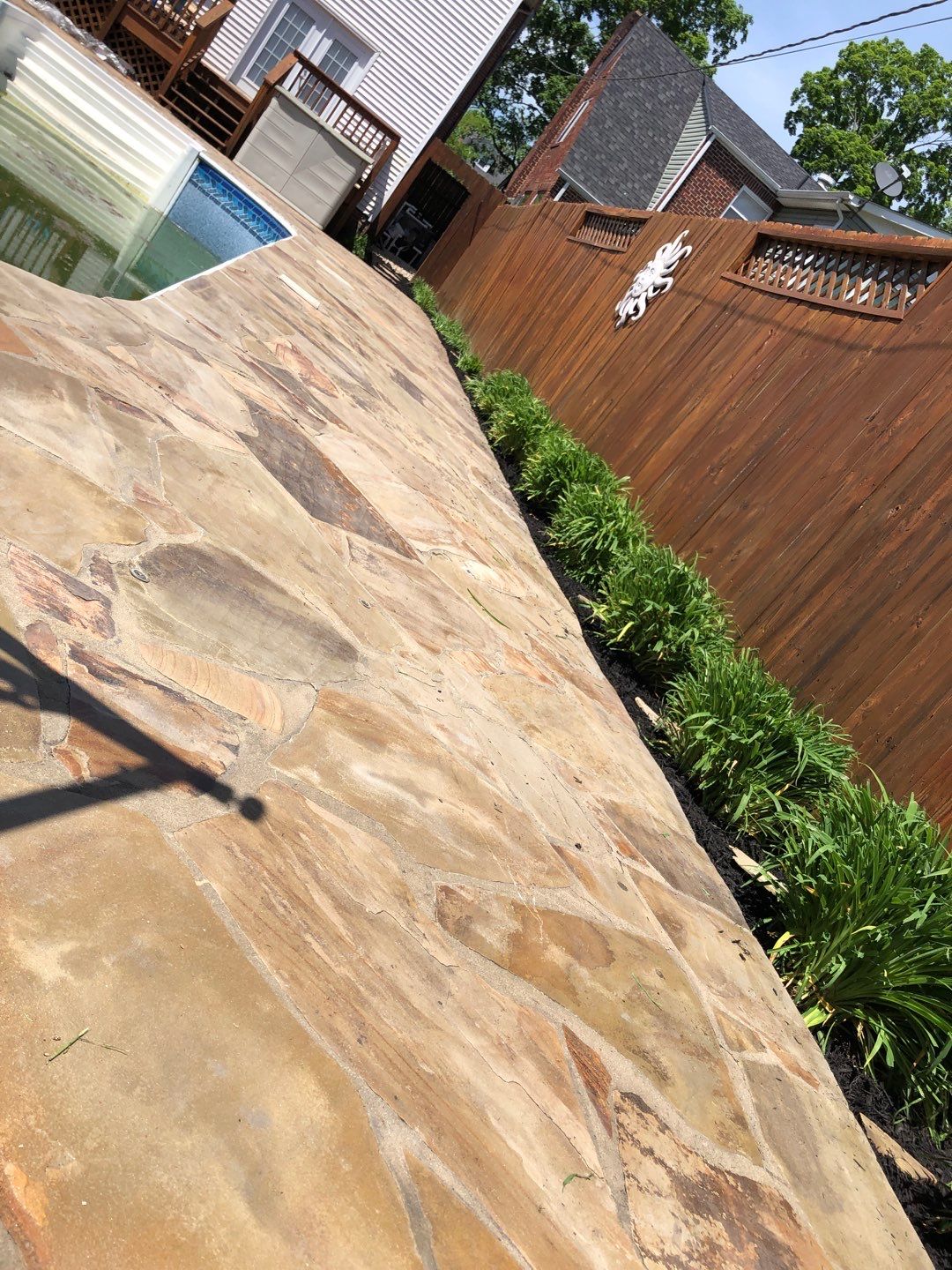 Liriope grasses, mulch and stone pavers by GrassBusters, Inc.
