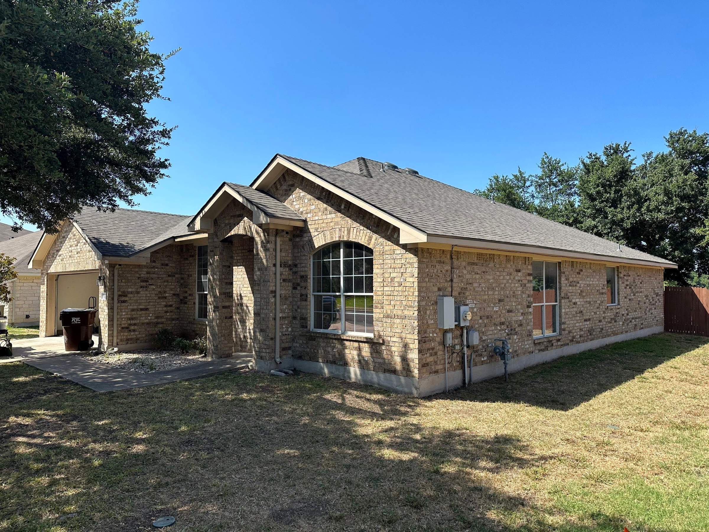 Driftwood Oakridge Roofing at a Round Rock Brick Home by Skywall Construction LLC