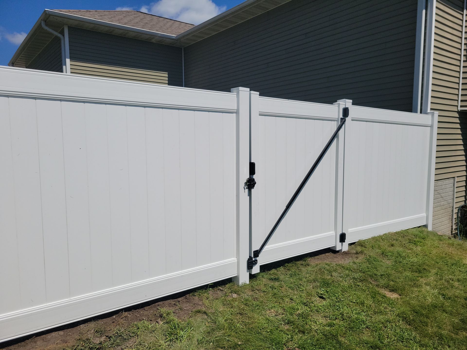 White Vinyl Privacy Fence and Ornamental Gate Installation in Janesville by Perfect Picket Fence and Stain