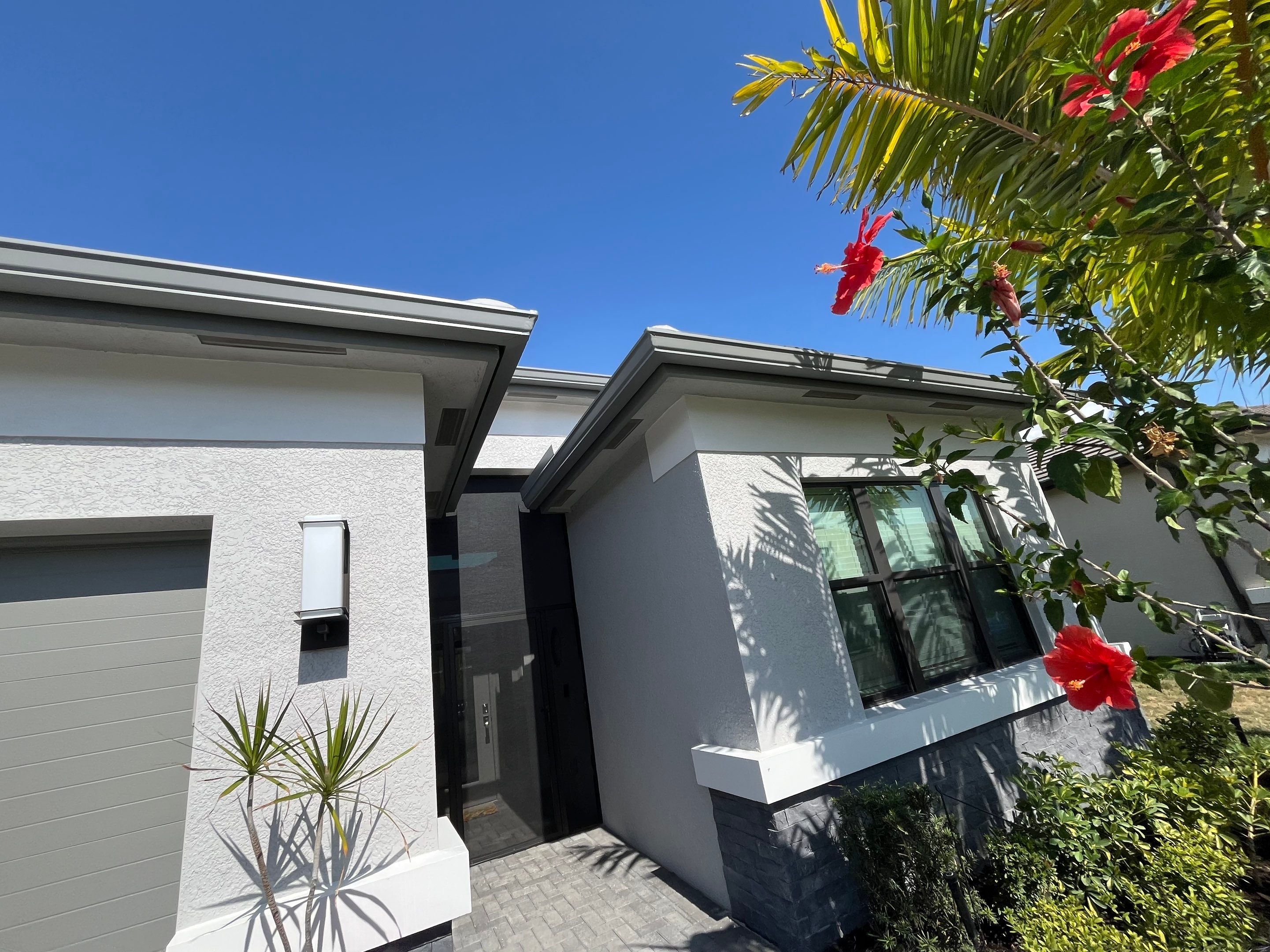 Grey Seamless Gutter Installation in Estero FL by Gutter Professors