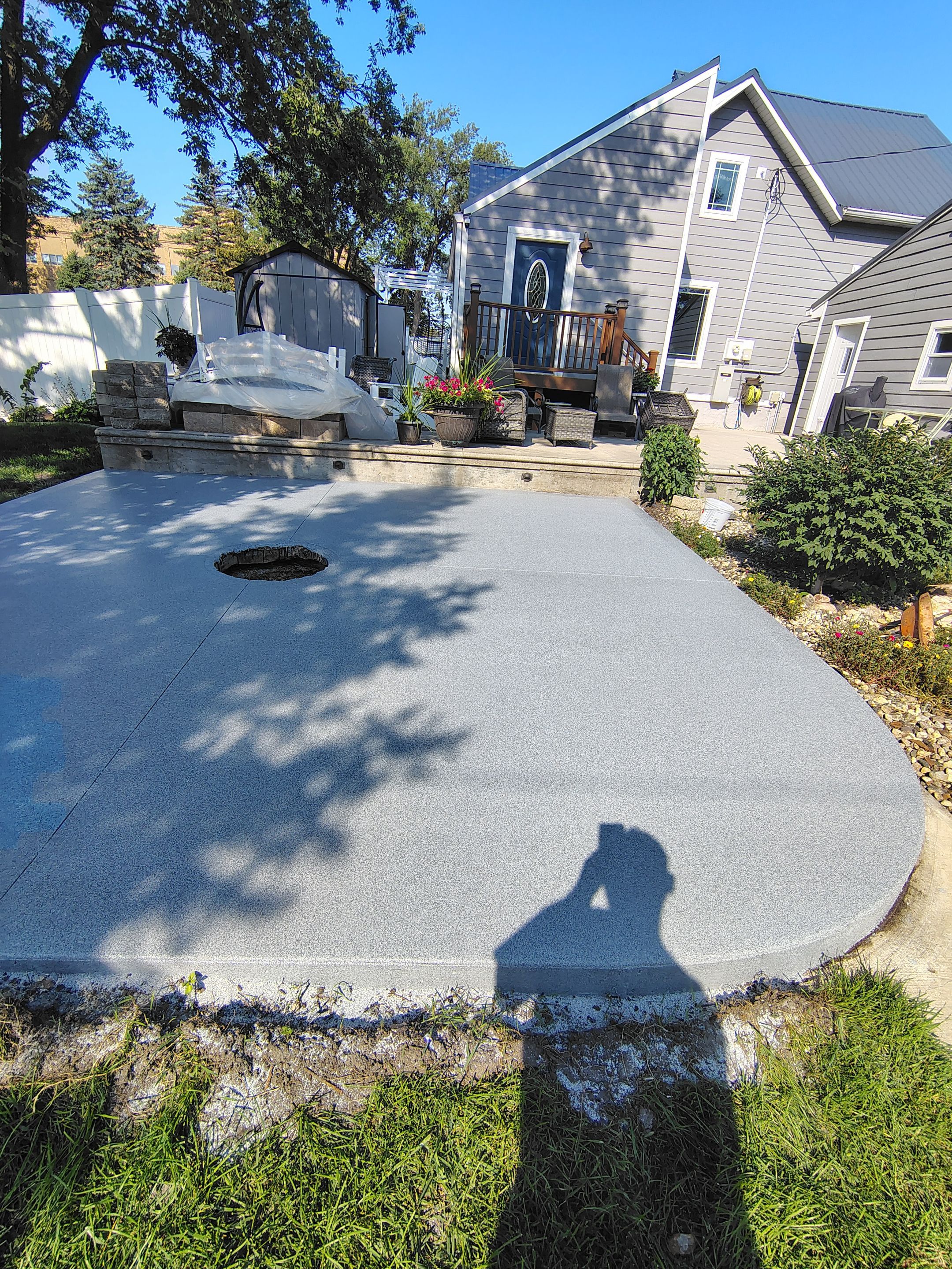 Custom Garage Floor Coating and Backyard Patio Refinishing in Tyndall by Select Painting, Coatings & Garage Cabinets