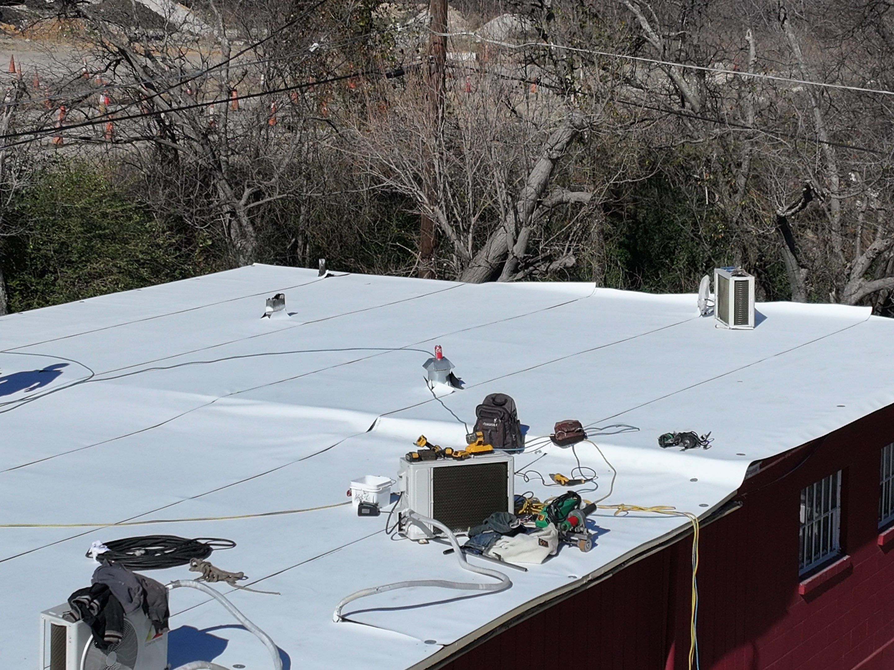 Commercial roofing overlay using GAF TPO over an old ballast roof by Becker Roofing and Exteriors