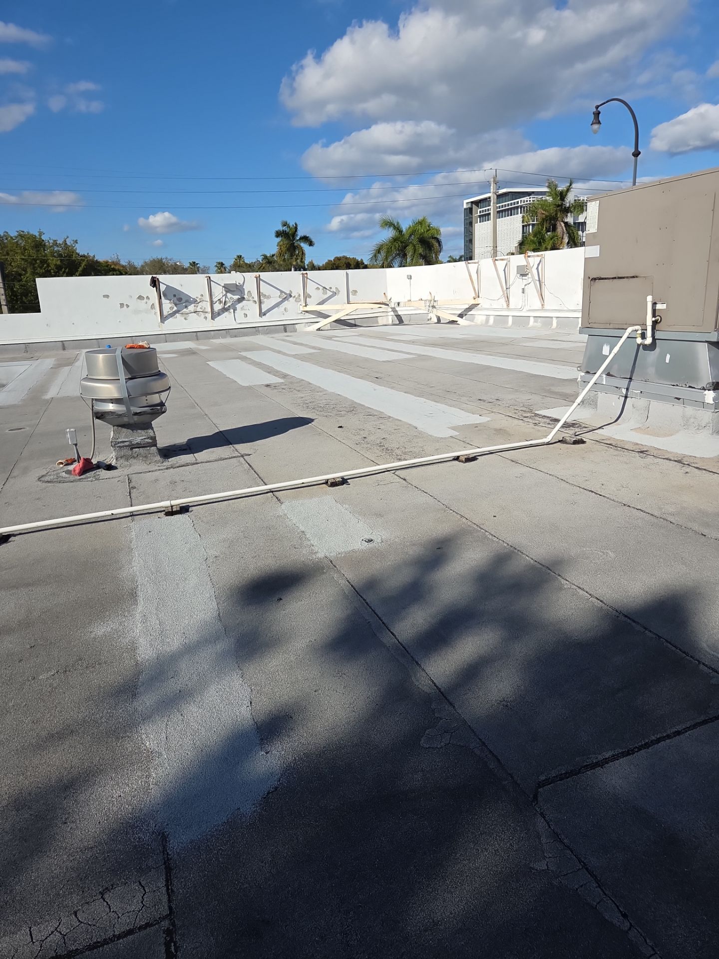 Commercial Flat Roof Restoration Using Silicone Coating in Hallandale Beach by Aastro Roofing