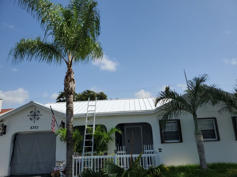 Residential Roofing Installation using 1.5" Nail Strip 24ga Solar White Kynar Coated Standing Seam Metal Panels by Morton Roofing, Inc.