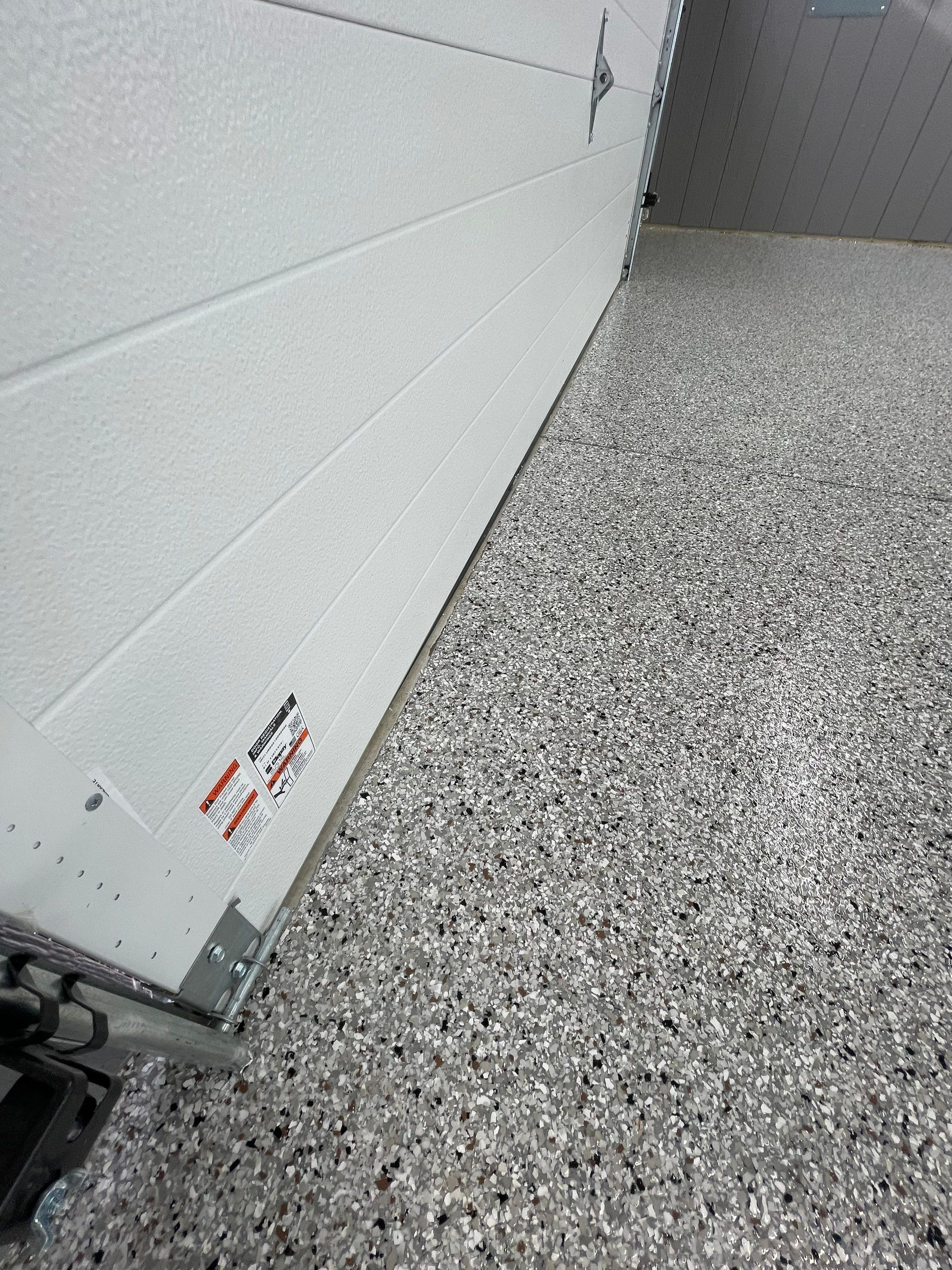 Speckled Epoxy Floor Coating for Large Shop in Rock Valley by Select Painting, Coatings & Garage Cabinets