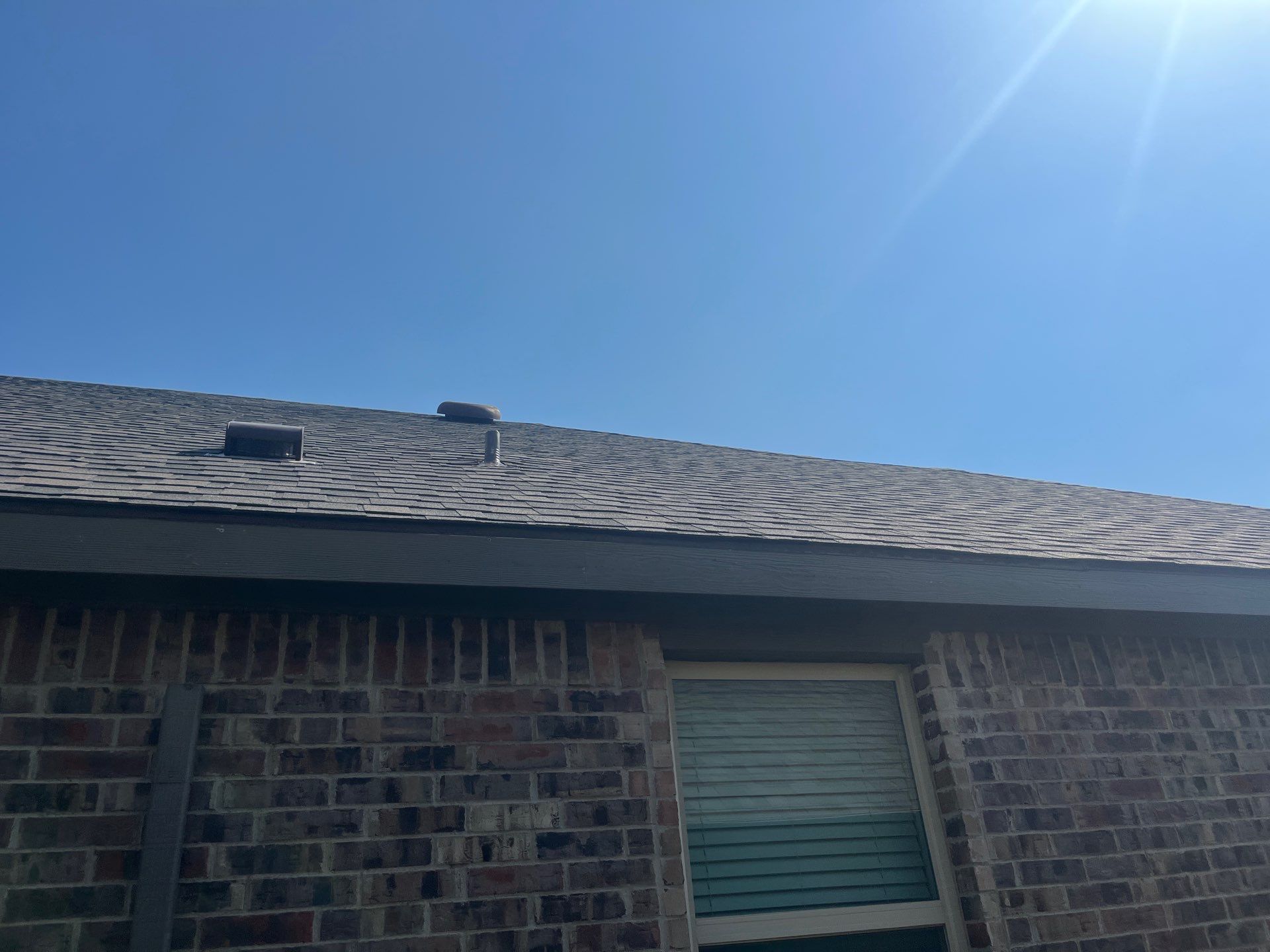 Medium brown brick with IKO Driftshake by Tejas Roofworks + Restoration