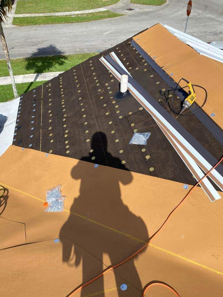 Standing Seam Metal & Flat Re-Roof using 1.5" Nail Strip 24ga Solar White Kynar Coated Standing Seam Metal Panels by Morton Roofing, Inc.