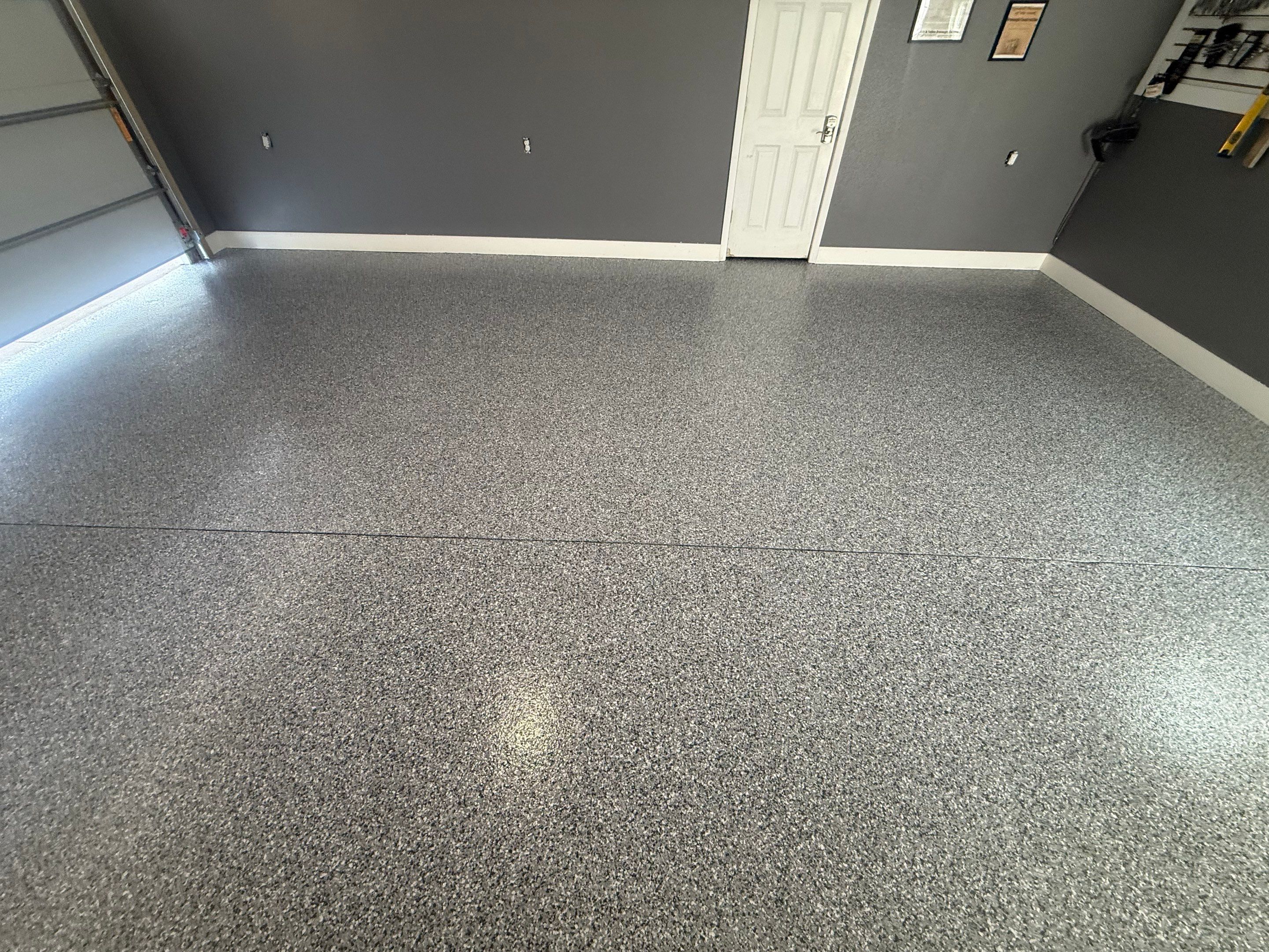 Custom Garage Floor Coating and Backyard Patio Refinishing in Tyndall by Select Painting, Coatings & Garage Cabinets