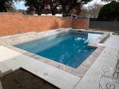 Geometric Pool with Raised Stone Wall and Sheer Descent