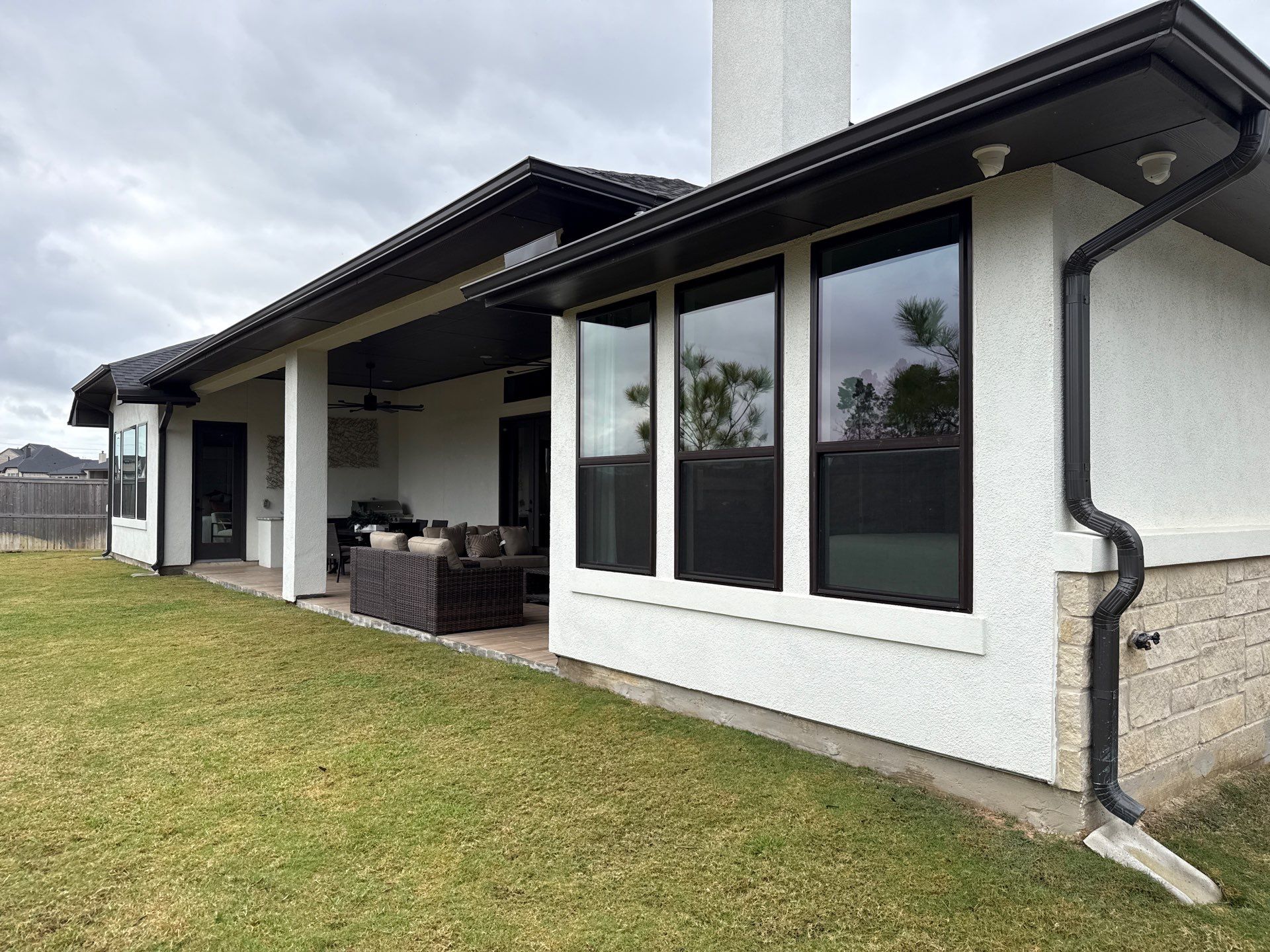 Magnolia Contrast: Light Stucco with Dark Accents and Stone Details by Apex Conventional Stucco Llc