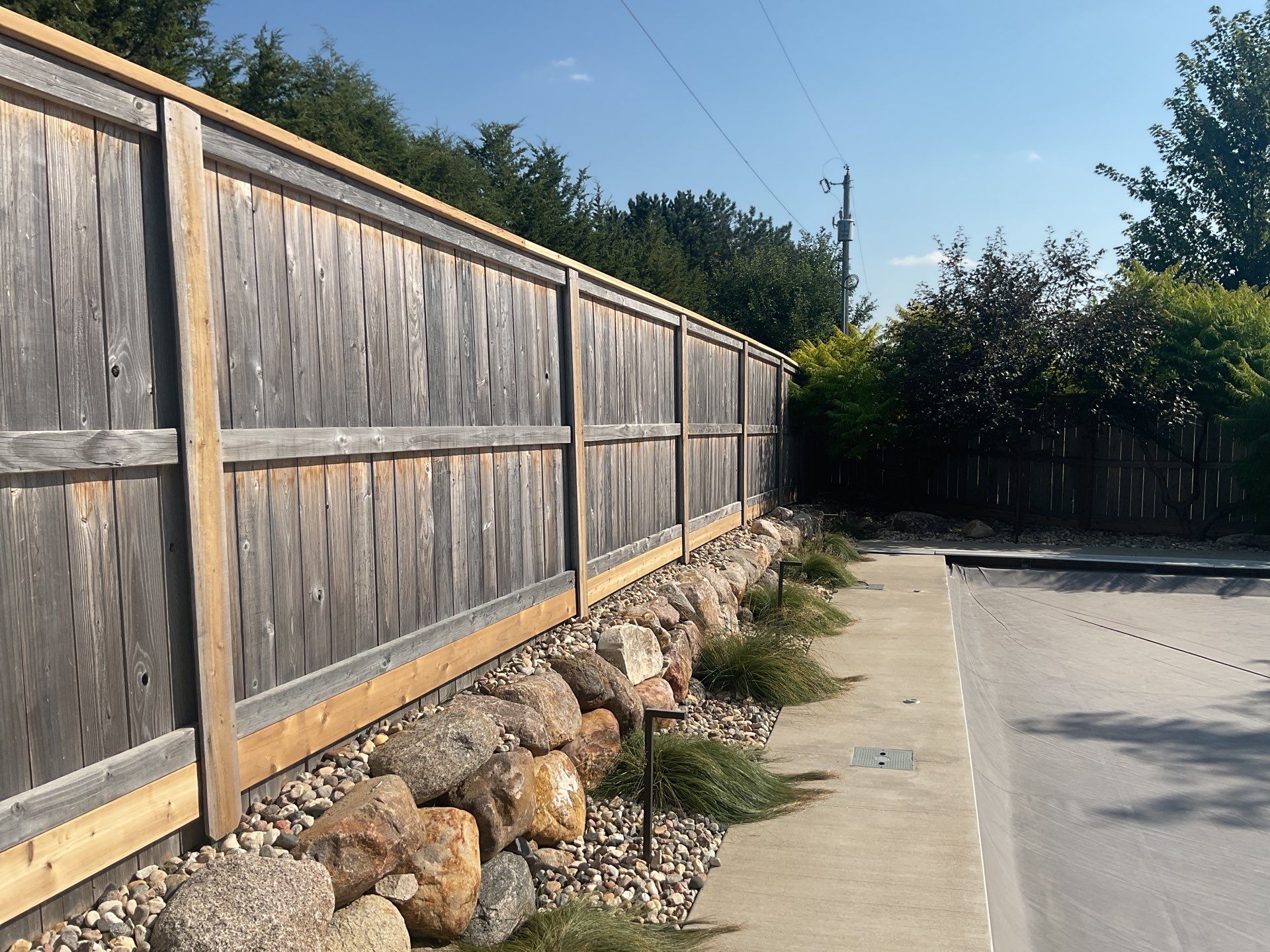 Custom Privacy Fence and Paver Patio Installation in Sioux Falls by Select Painting, Coatings & Garage Cabinets