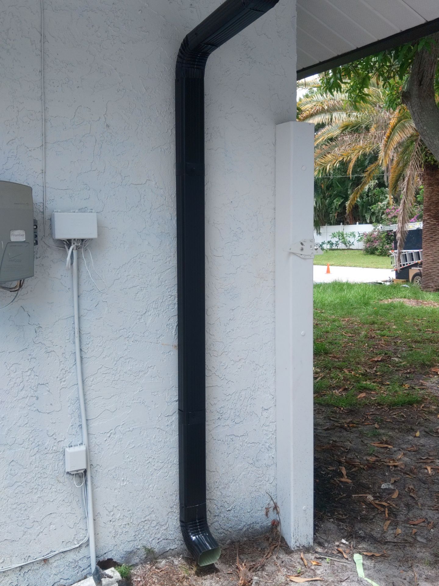 Black seamless gutters and downspouts installation in Sarasota, FL by Gutter Professors