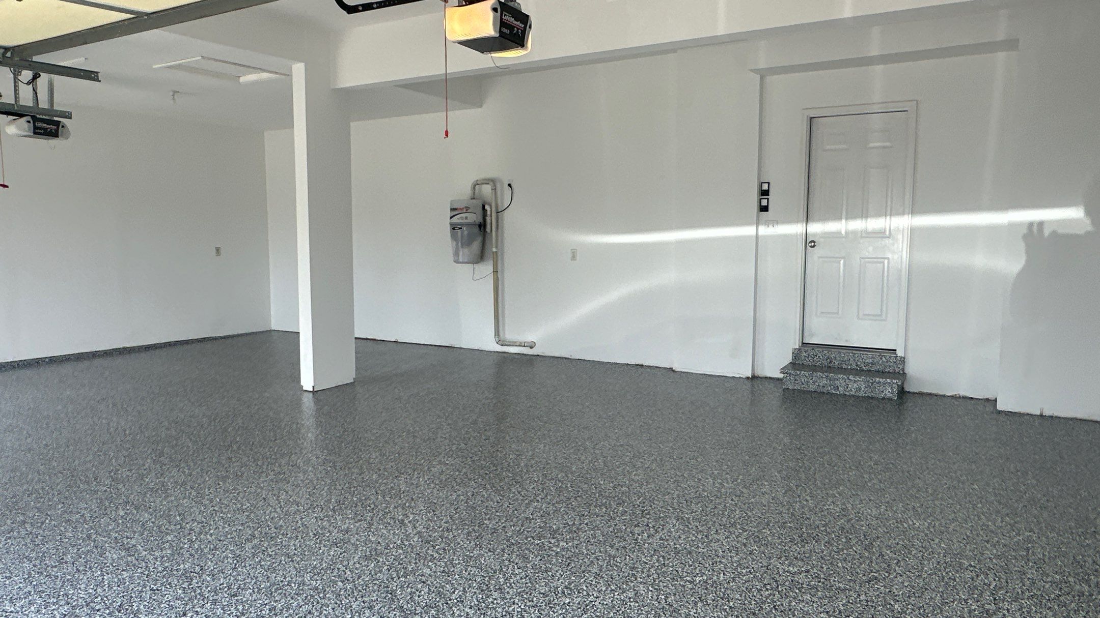 Laura B. garage transformation with a new floor and garage storage  by Banner Garage