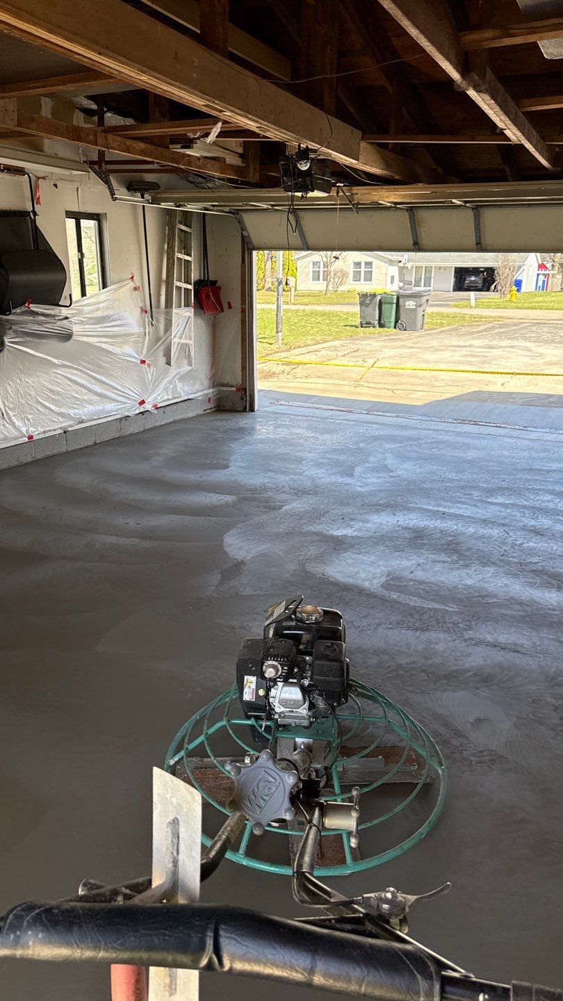 Concrete garage floor replacement with a broom finished apron and drain  by NG Masonry & Construction LLC