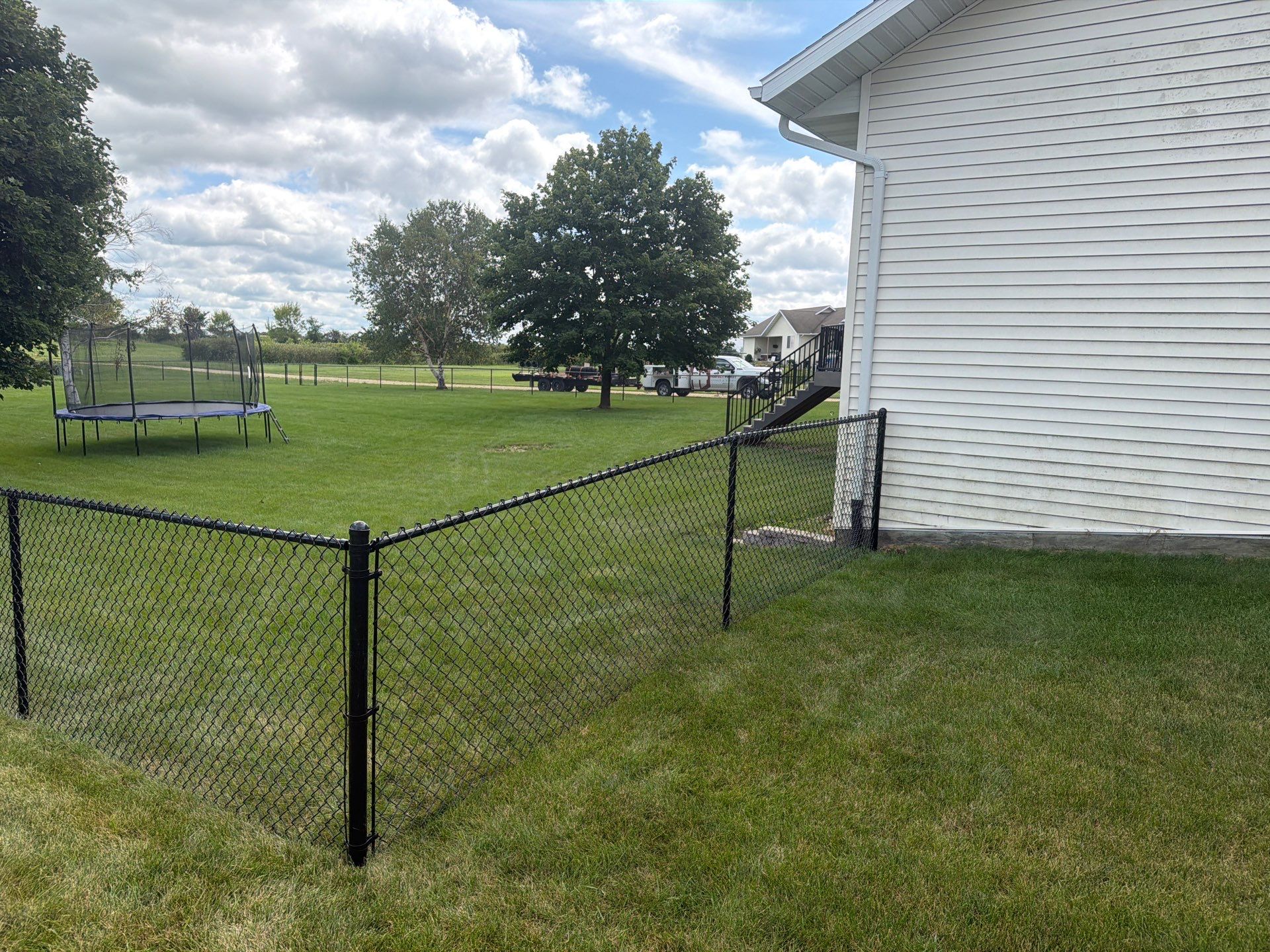 Black Vinyl-Coated Chain Link Fence Installation in Fairbank by Perfect Picket Fence and Stain
