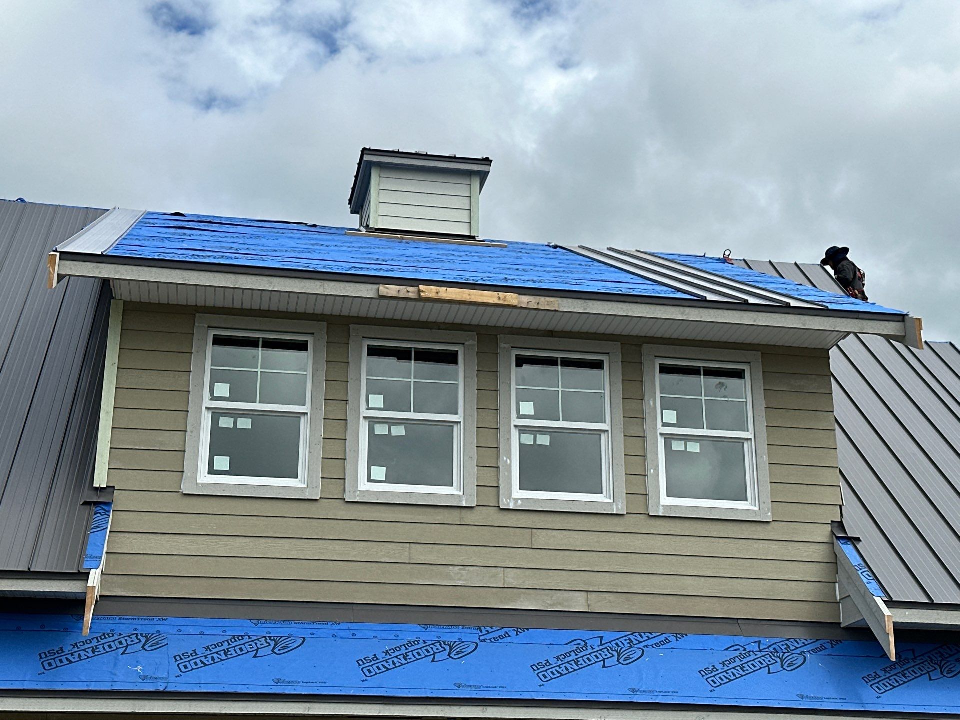 Residential Roofing Installation using 12" Prolok metal  by Top Notch Roofing Inc