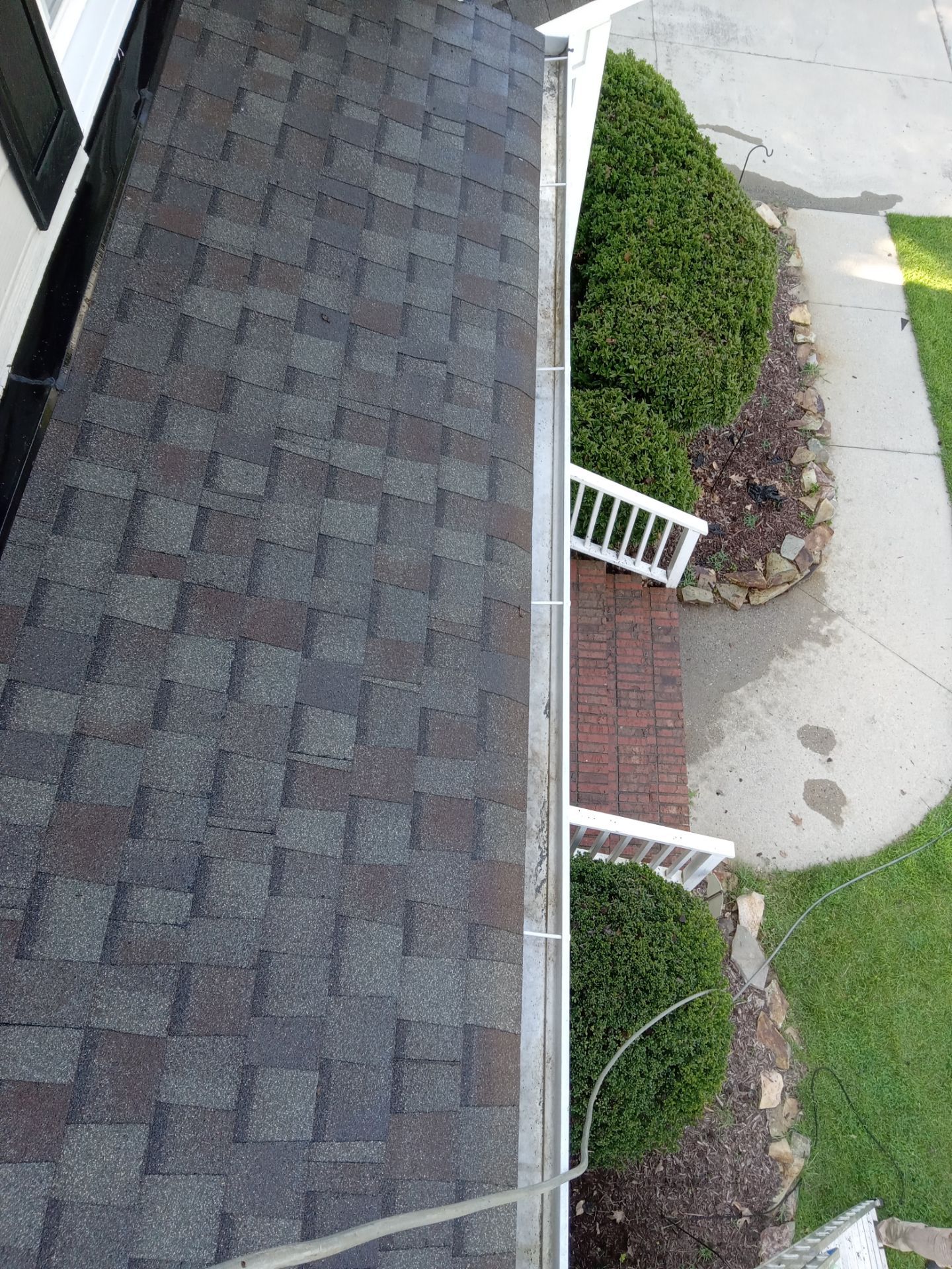 pressure washing roof shingles walkway and brick steps removing dirt and grime restoring surfaces appearance