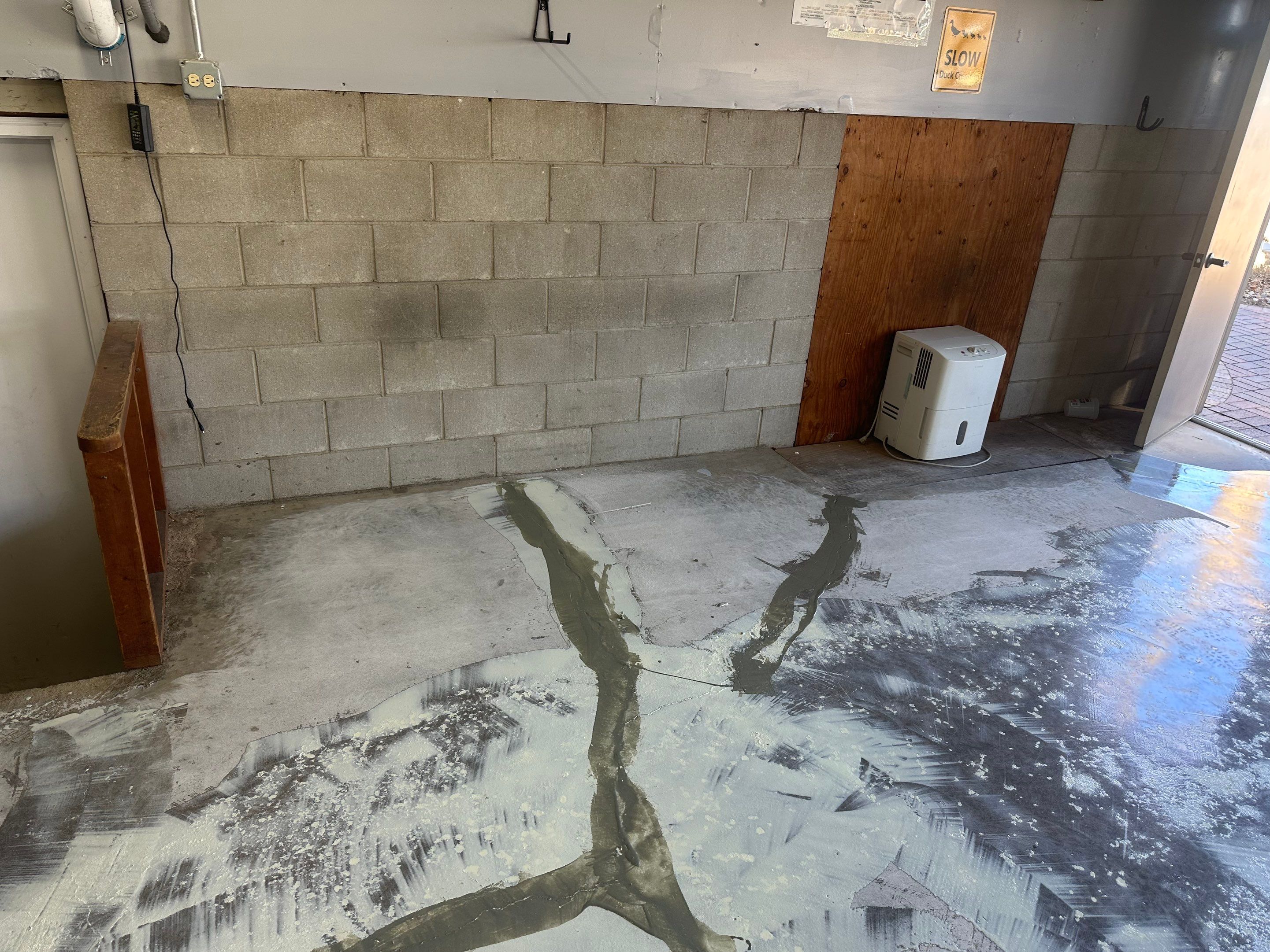 Multi-Colored Speckled Concrete Floor Coating Installation in Sioux Falls by Select Painting, Coatings & Garage Cabinets