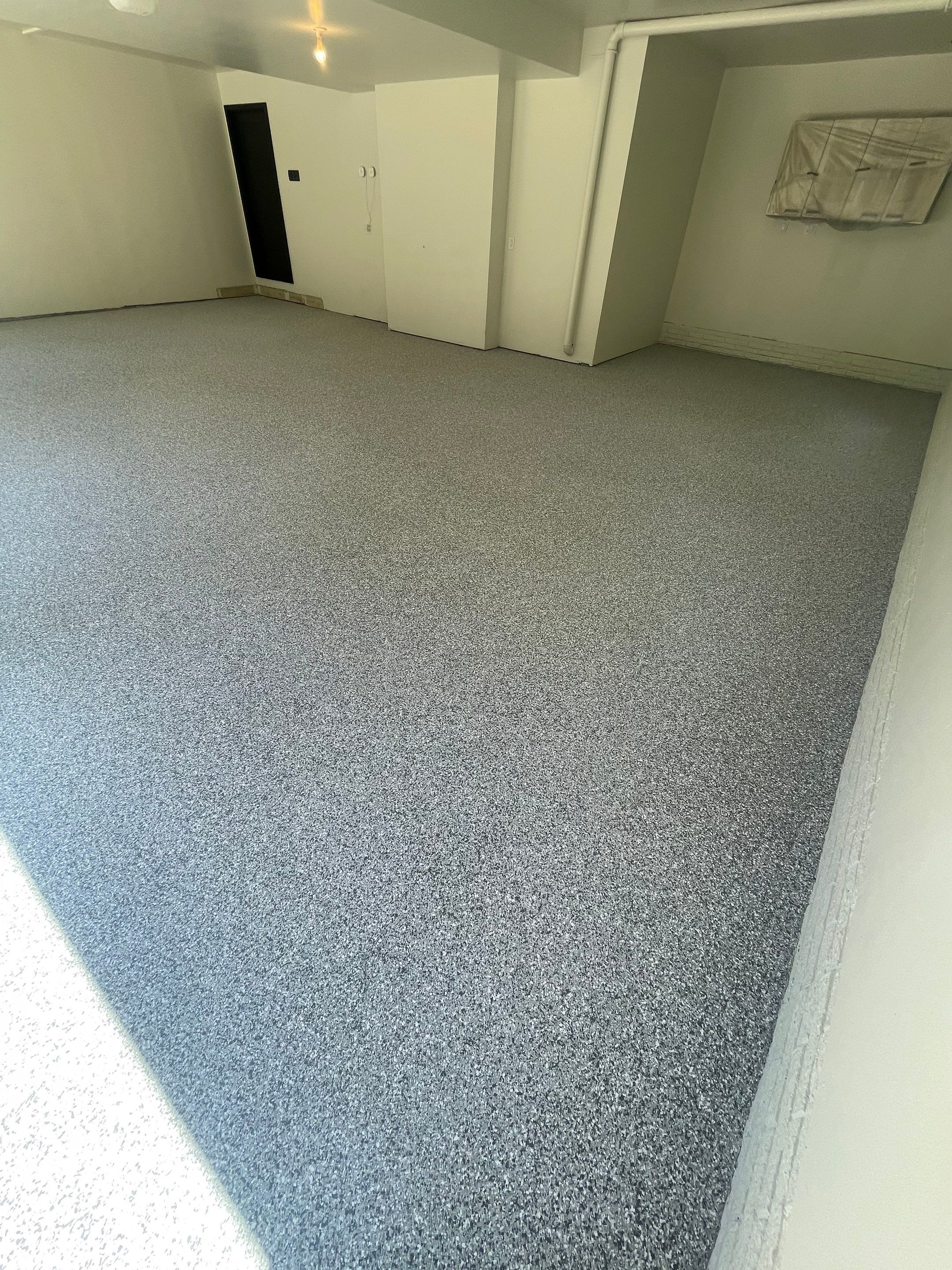 Gray Speckled Epoxy Garage Floor Coating in Sioux Falls by Select Painting, Coatings & Garage Cabinets