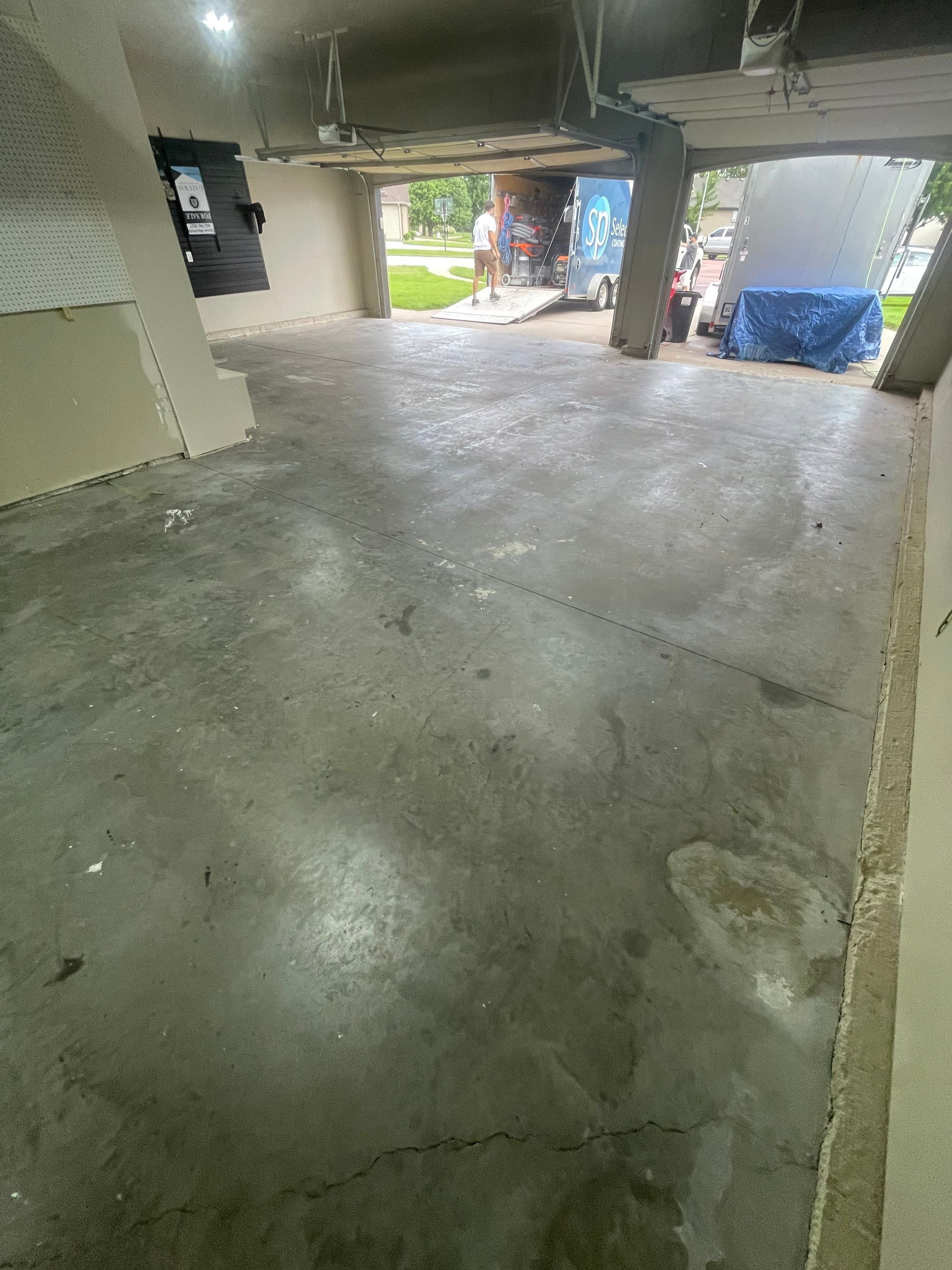 Cabin FEver Flake Garage Floor Coating Installation in Sioux Falls by Select Painting, Coatings & Garage Cabinets