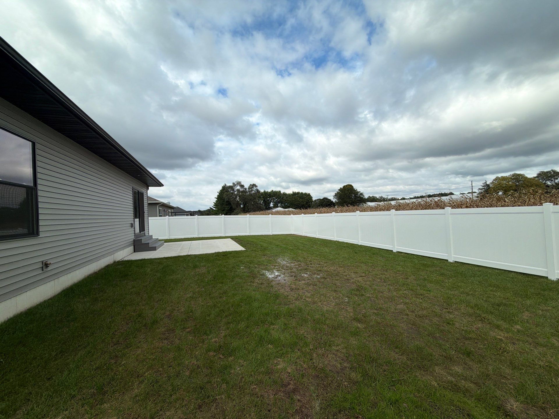 Residential White Vinyl Privacy Fence Installation in Janesville by Perfect Picket Fence and Stain