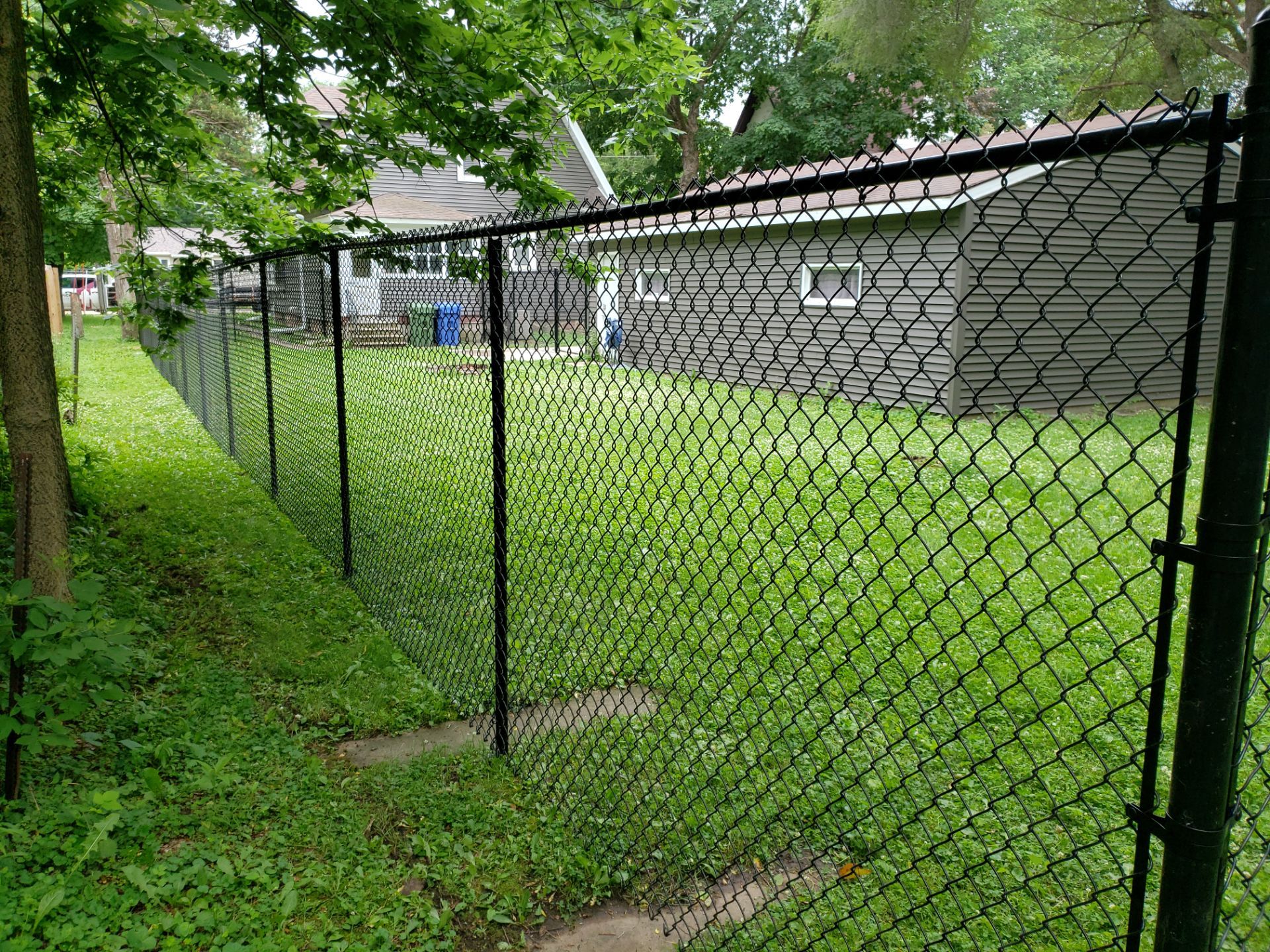 Black Vinyl Chain Link Fence Installation in Charles City by Perfect Picket Fence and Stain