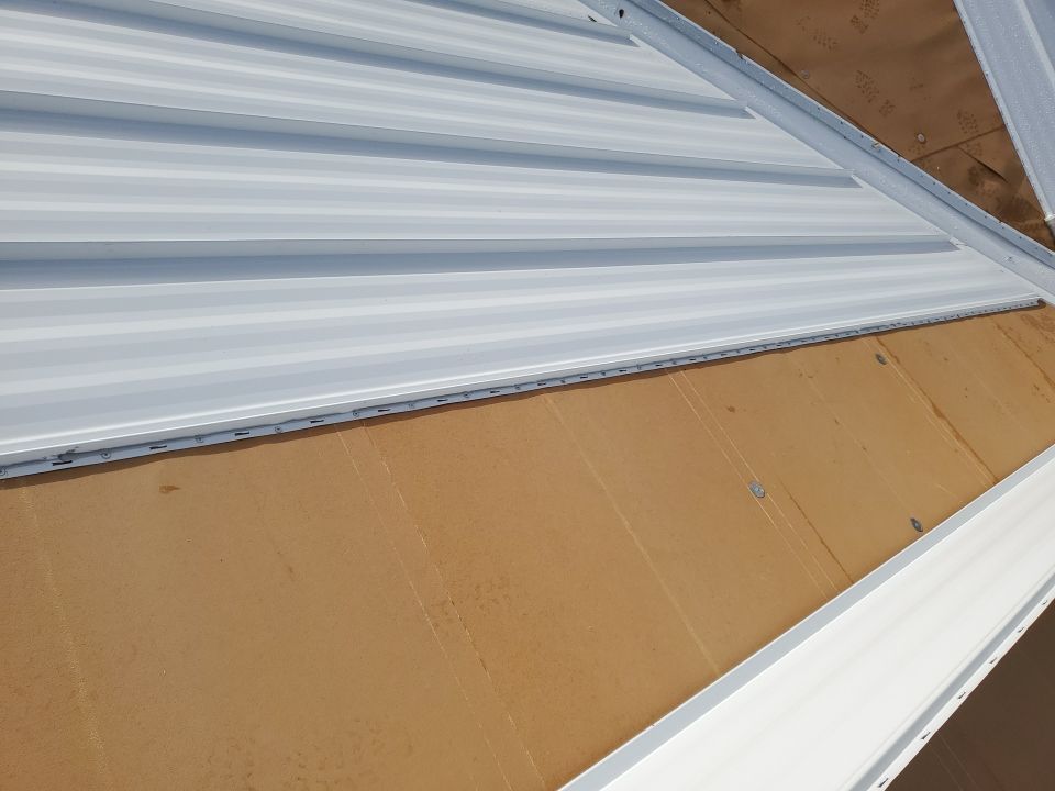 Residential Roofing Installation using 1.5" Nail Strip 24ga Solar White Kynar Coated Standing Seam Metal Panels by Morton Roofing, Inc.