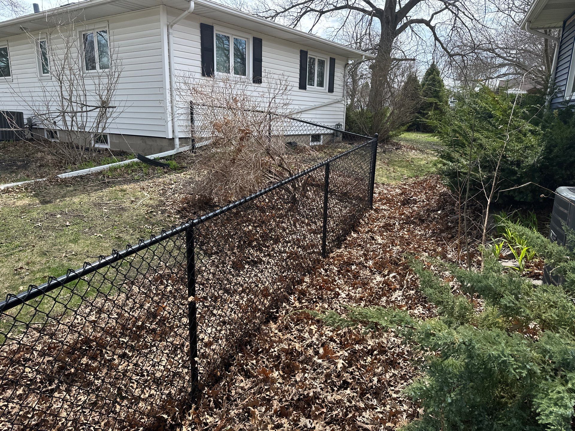 Black Vinyl-Coated Chain Link Fence Installation in Cedar Falls by Perfect Picket Fence and Stain