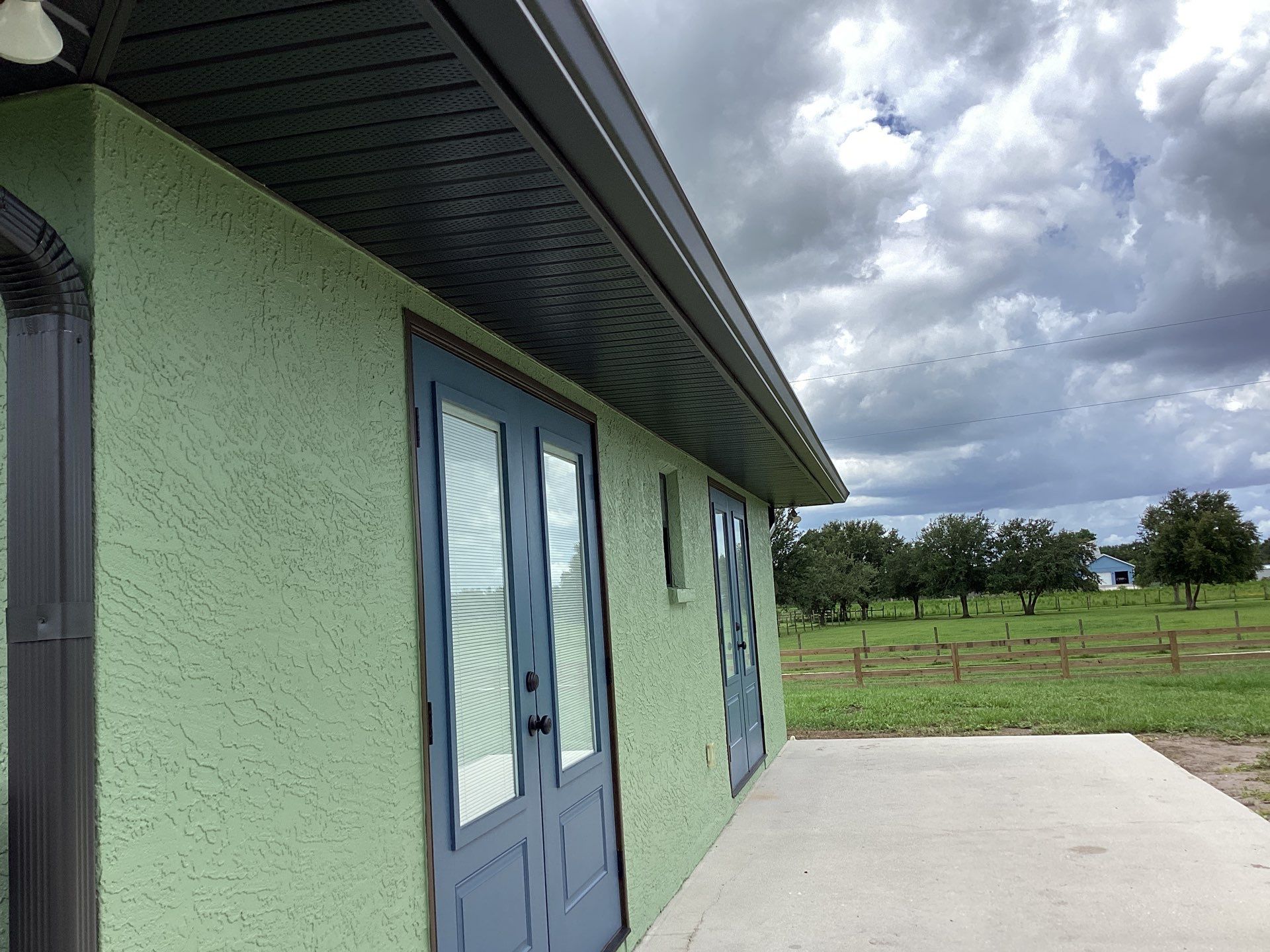 Musket brown downspouts with 6-inch K-Style gutter installation in Myakka City, FL by Gutter Professors