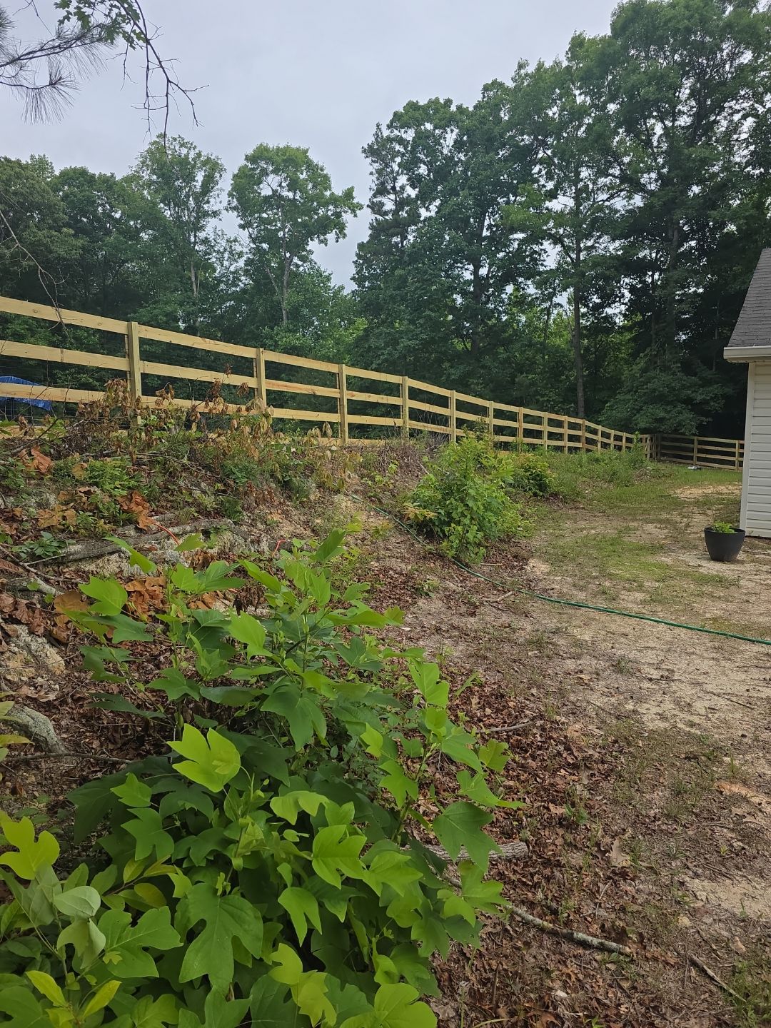 Fence Installation of a 4 Rail Ranch Style Fence with Welded Wire by Titans of Timber Fence & Stain