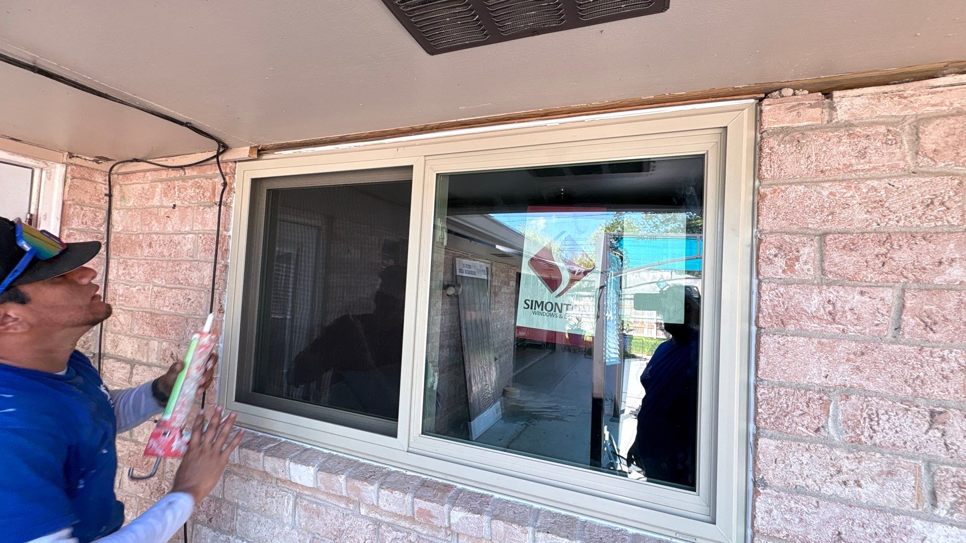 Colored Vinyl Windows to blend into brick by Bayfront Roofing and Construction