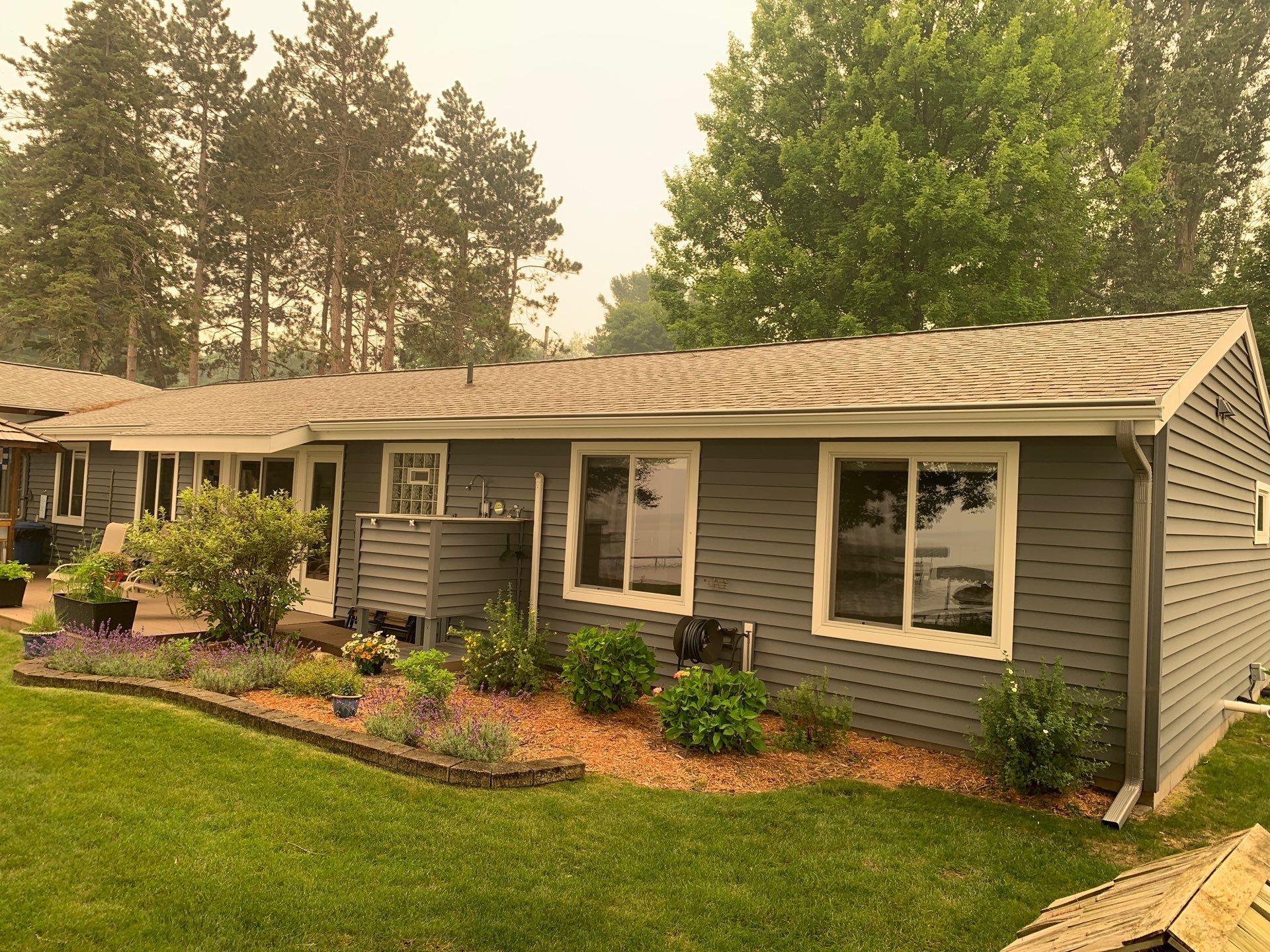 Gutter Helmet and White Seamless Gutter Installation in Rapid City by Rainbow Seamless Systems