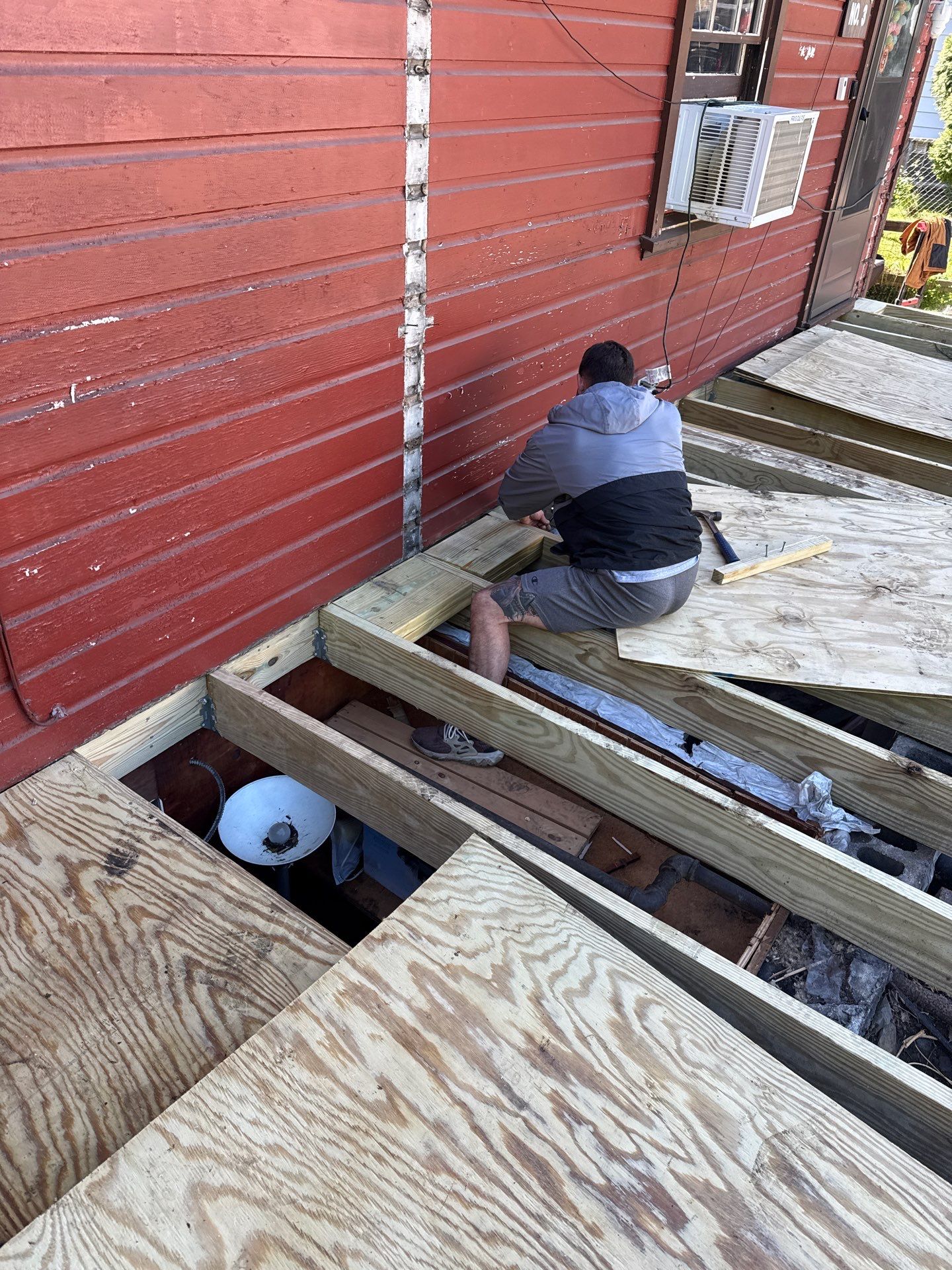 Roof sunspace deck  by Cousins Roofing Siding & Decks