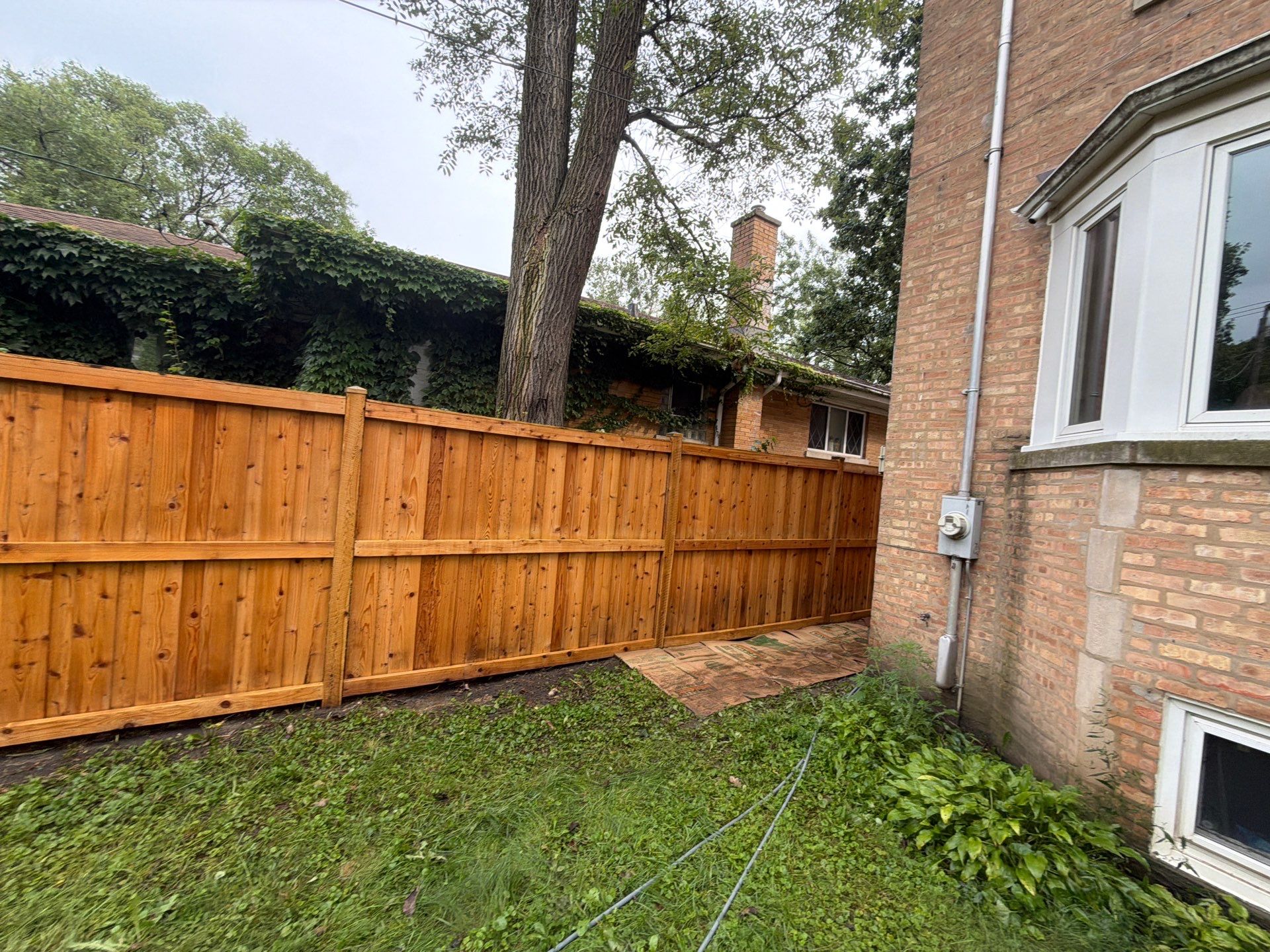 Wood fence cleaning and sealing by Northern Power Washing LLC.