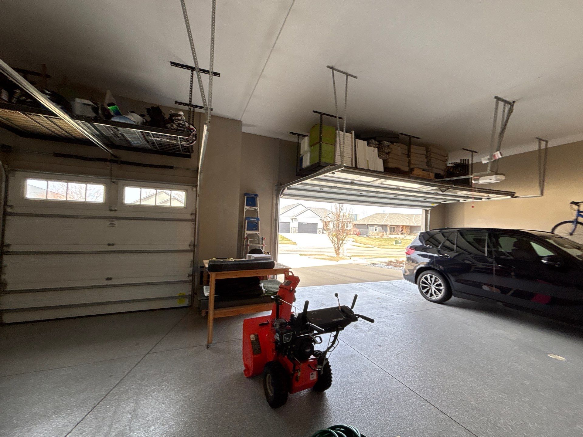 Speckled Grey Epoxy Garage Floor Coating Installation in Tea by Select Painting, Coatings & Garage Cabinets