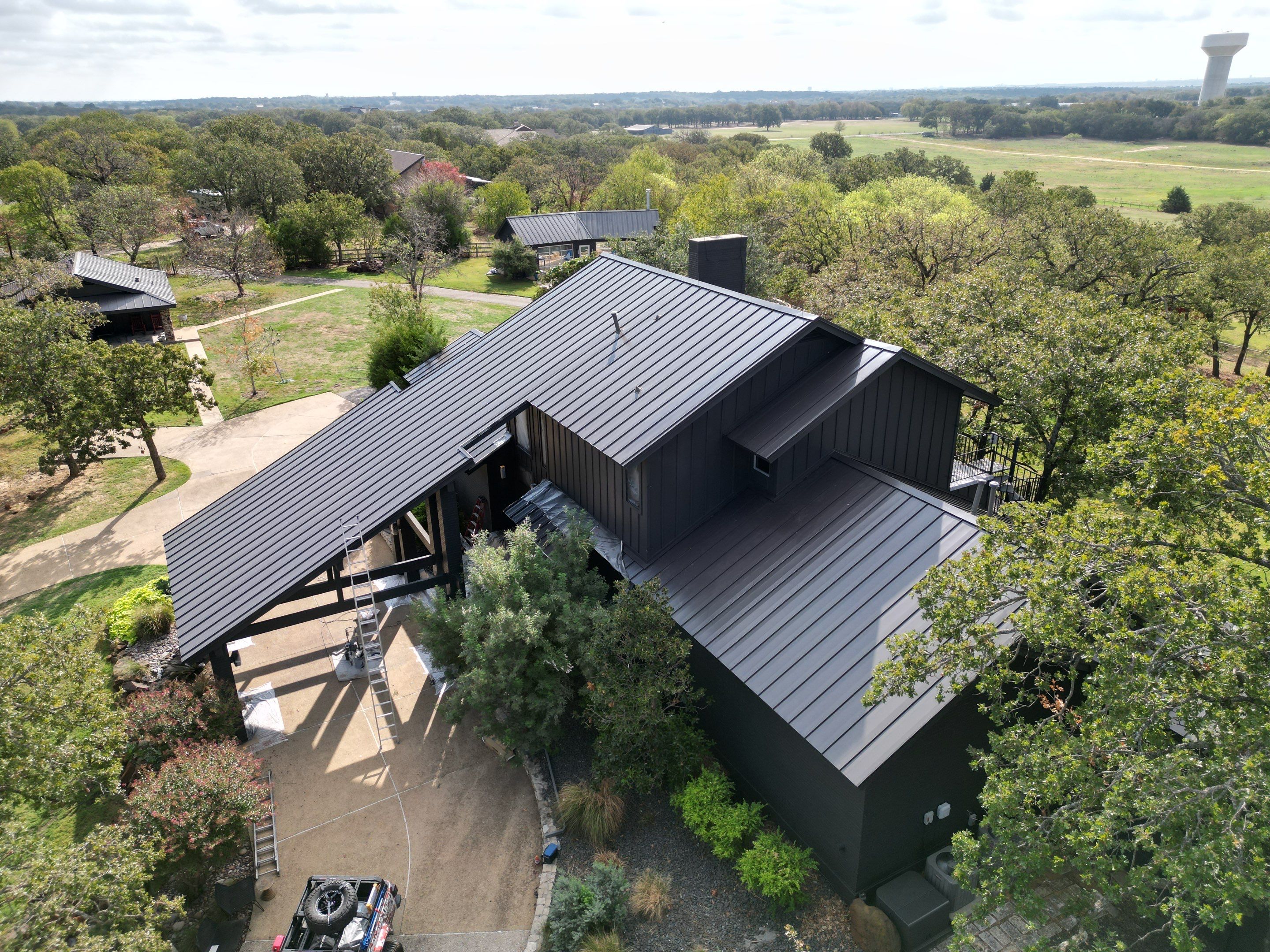 Dark Bronze Standing Seam Metal Roof by First Out Roofing 
