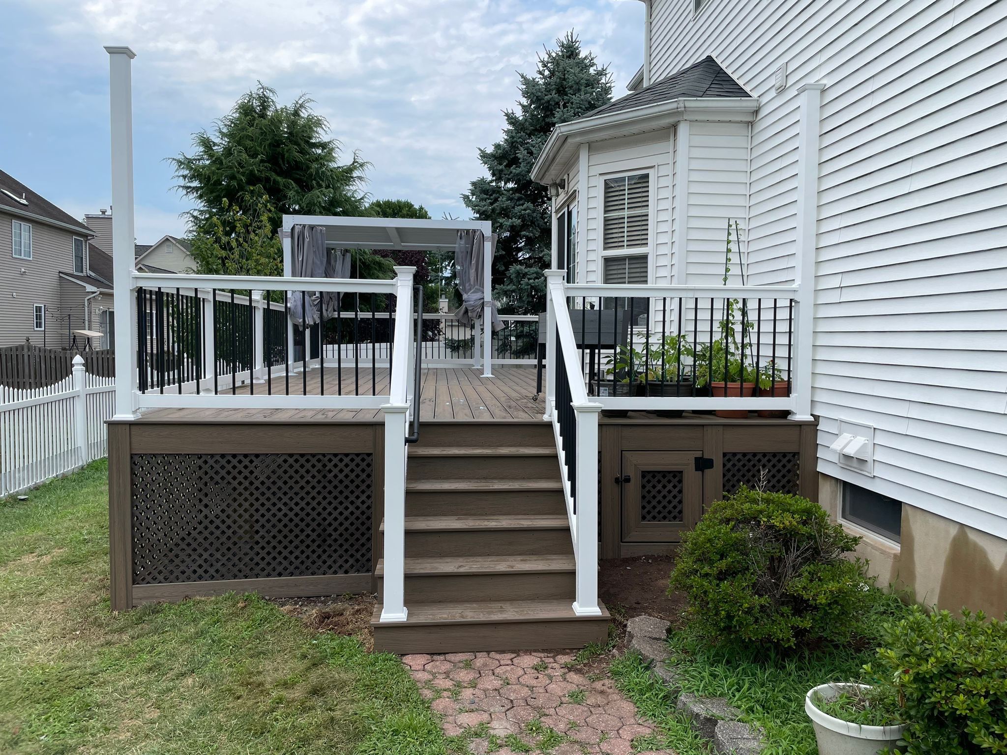 New Deck with Pergola and Vinyl Lattice by deck guardian