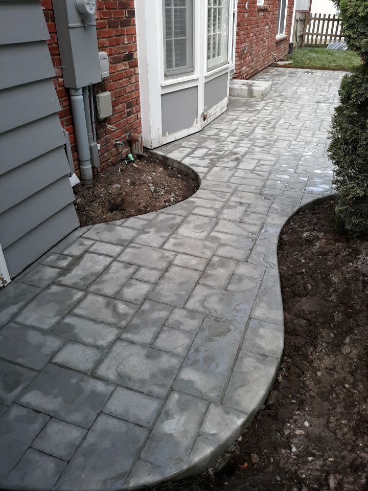 Back Yard Stamped Patio by LAND ESCAPES LLC