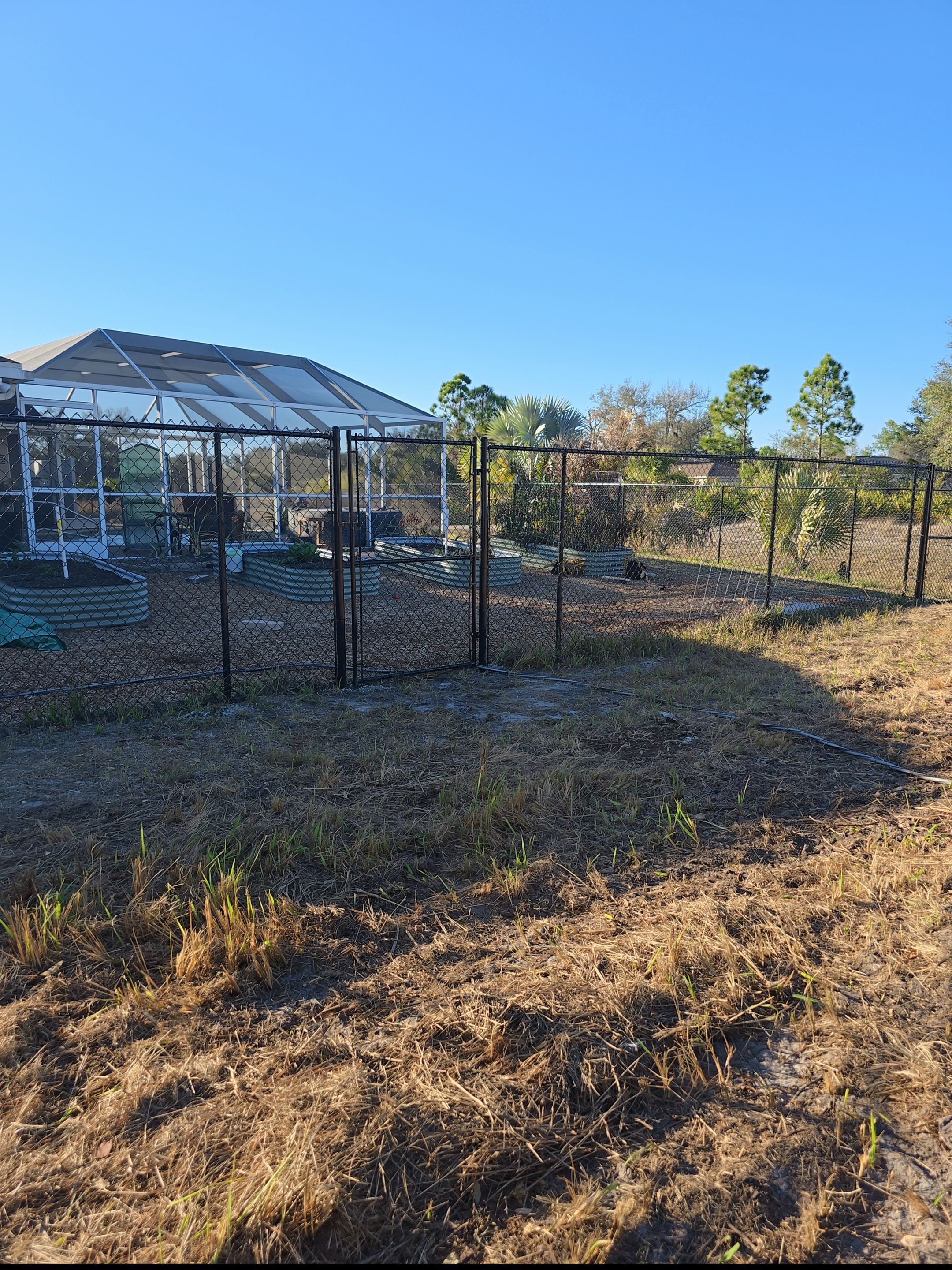 Black Vinyl-Coated Chain Link Fence and Gate Installation in North Port by True Fence LLC