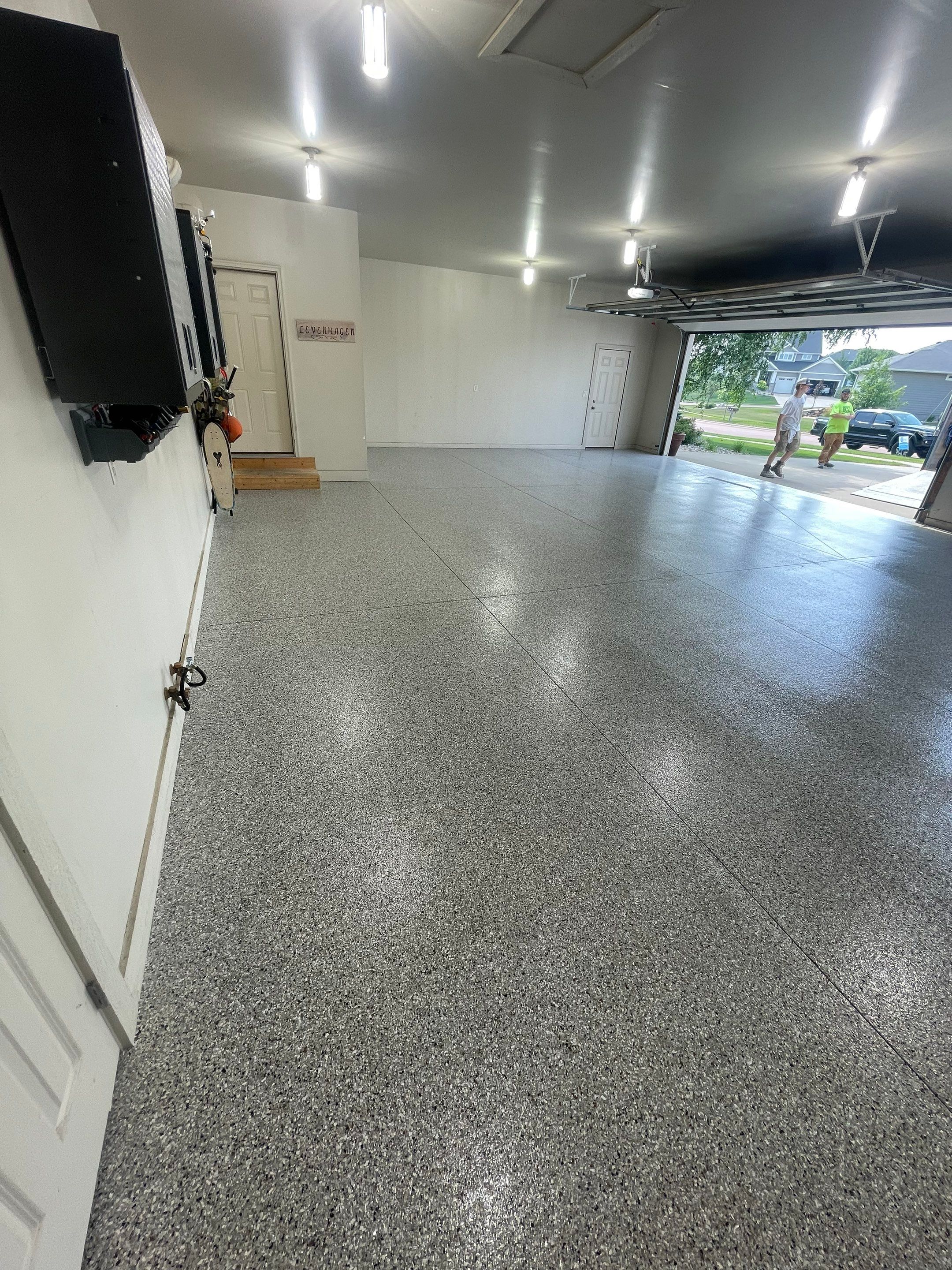 Coyote Flake Garage Floor Coating in Sioux Falls with Trench Drain by Select Painting, Coatings & Garage Cabinets