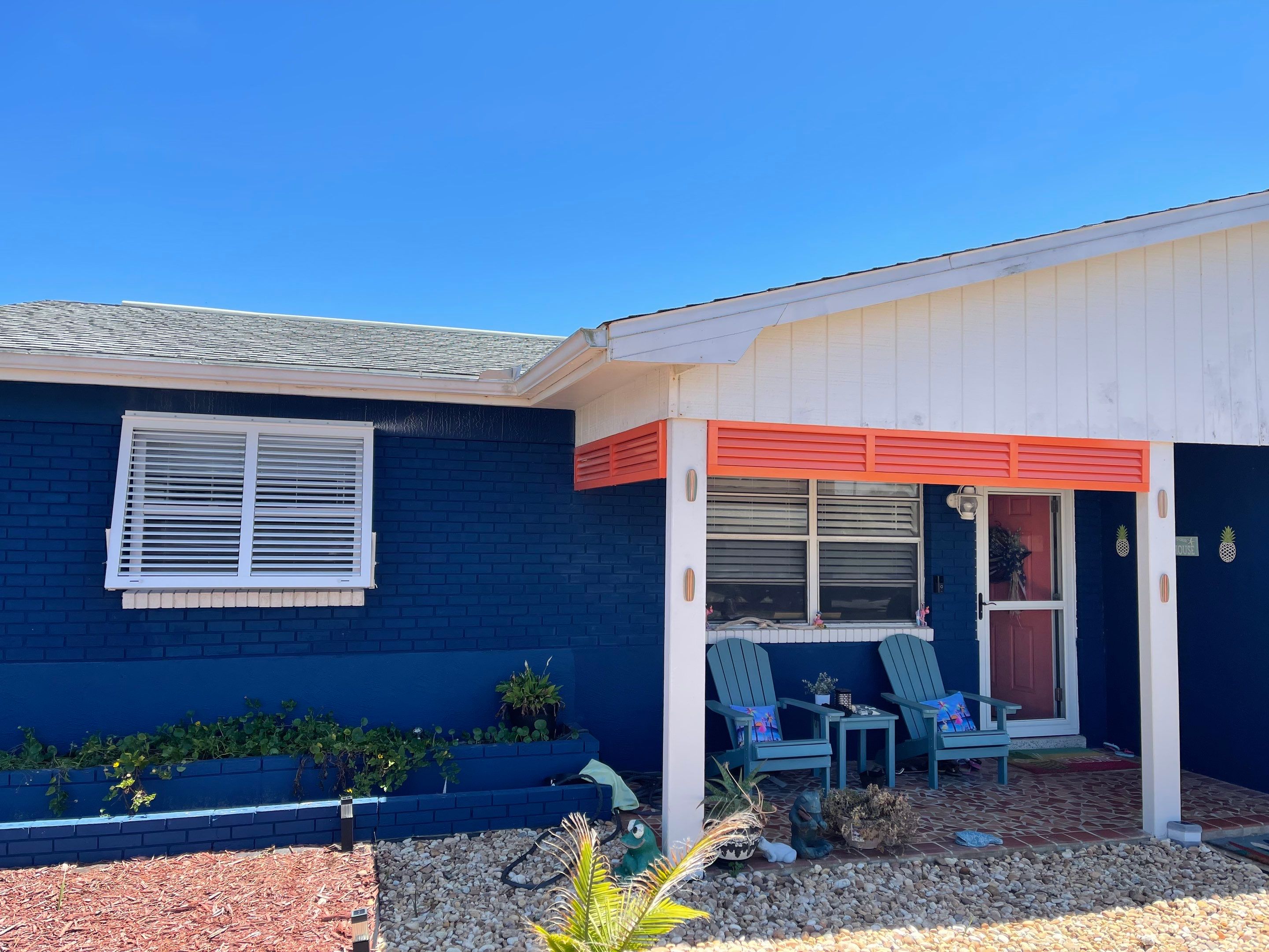 White & Coral Bahama Shutters by Smart Guard Shutters